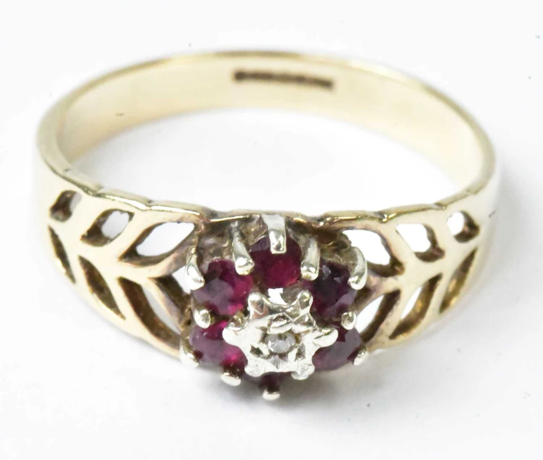 A 9ct yellow gold floral cluster ring set with a central...