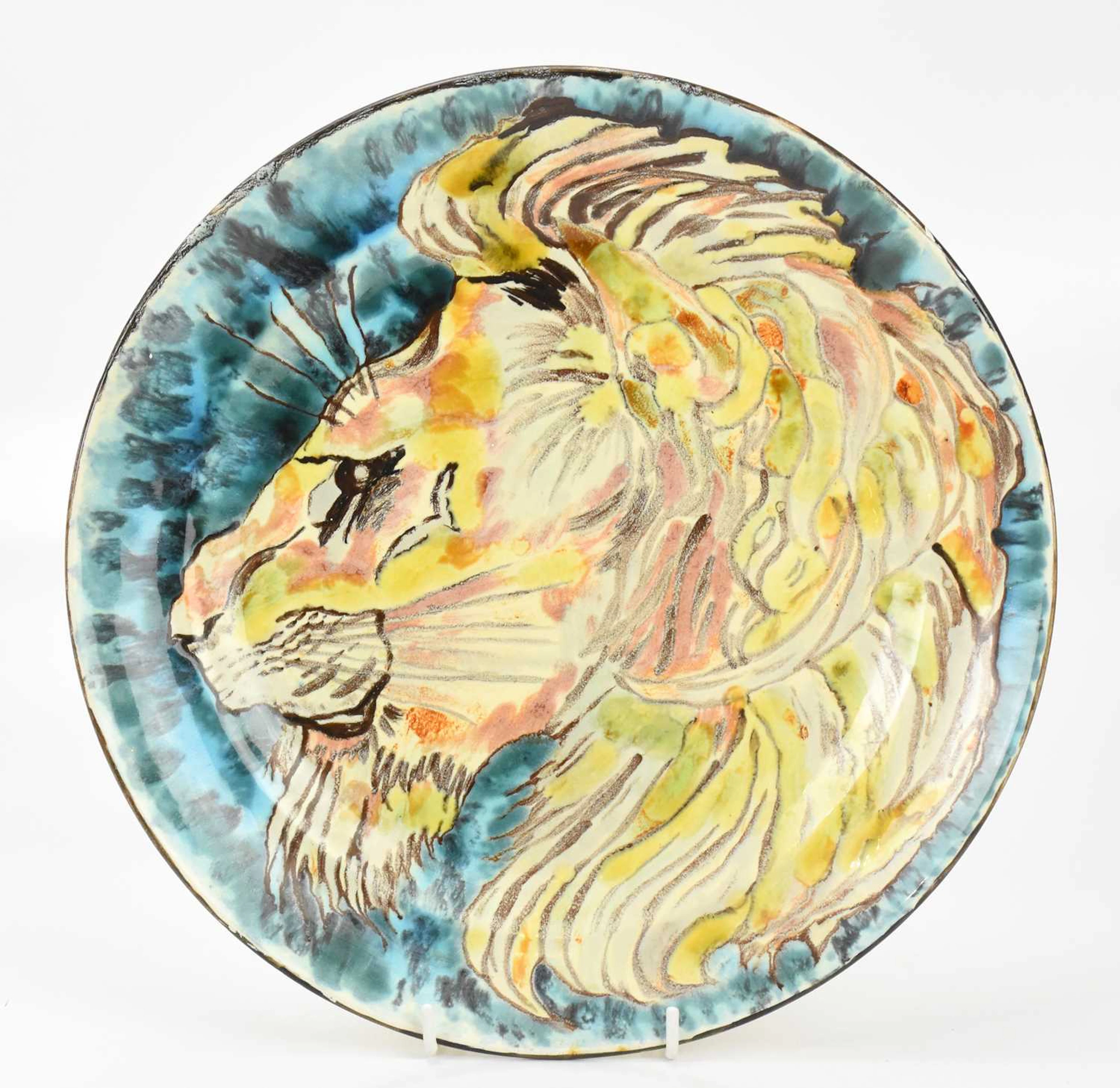 POOLE STUDIO; an early ceramic plate decorated with an abstract lion