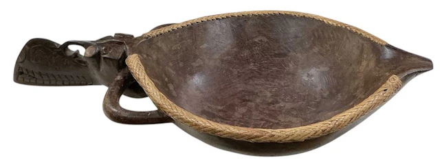 An Indonesian tribal carved wooden figural Dayak Aso bowl