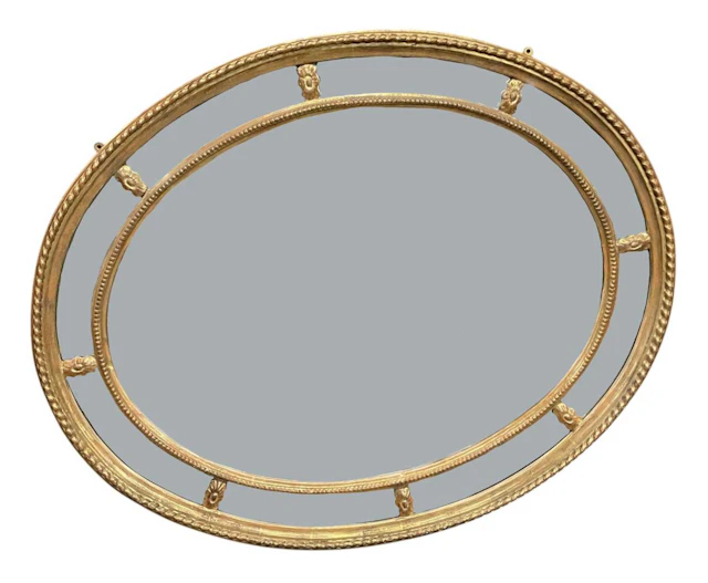 A modern oval gilt framed bevelled glass wall mirror