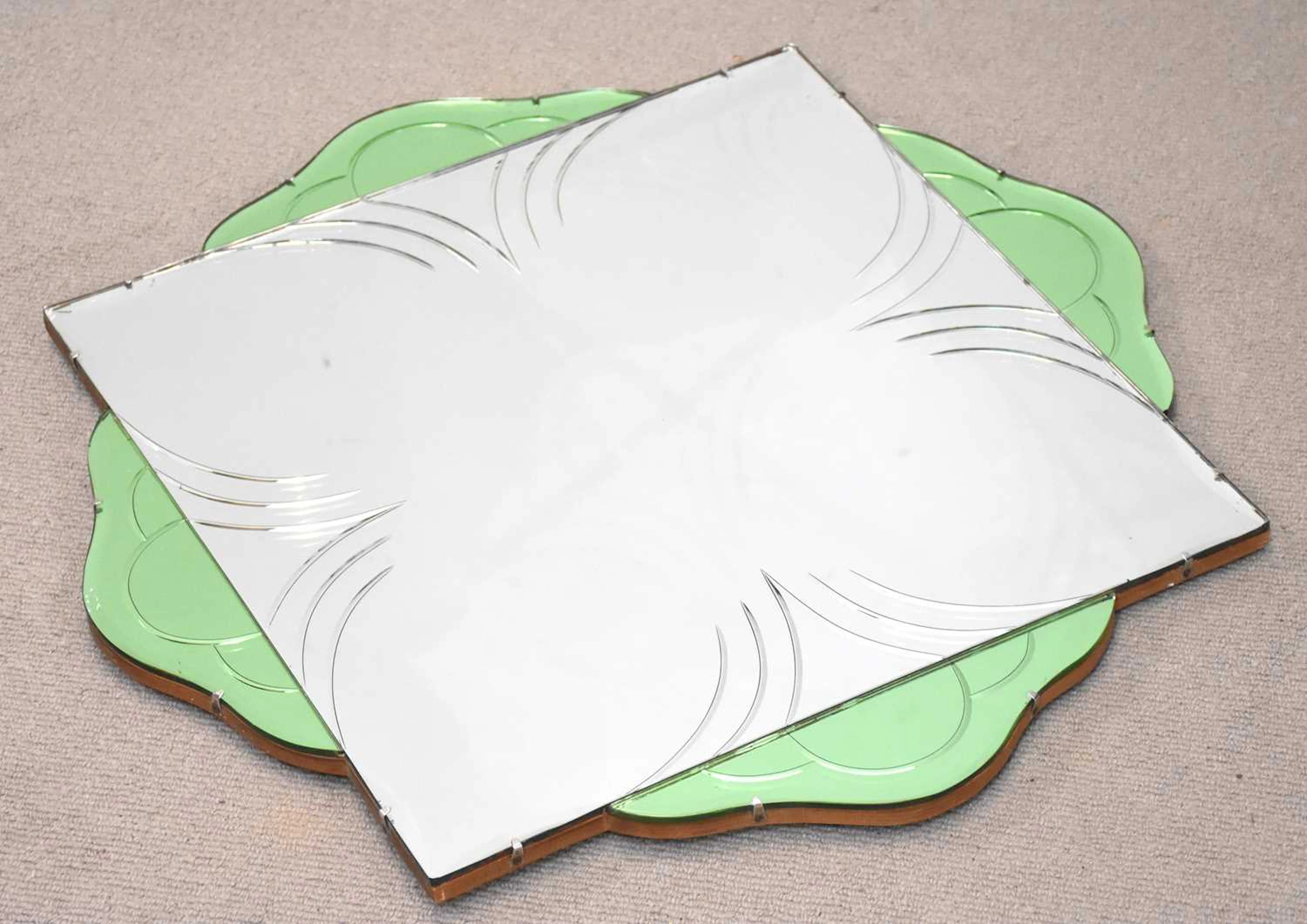 An Art Deco green and clear glass wall mirror of shaped circular form