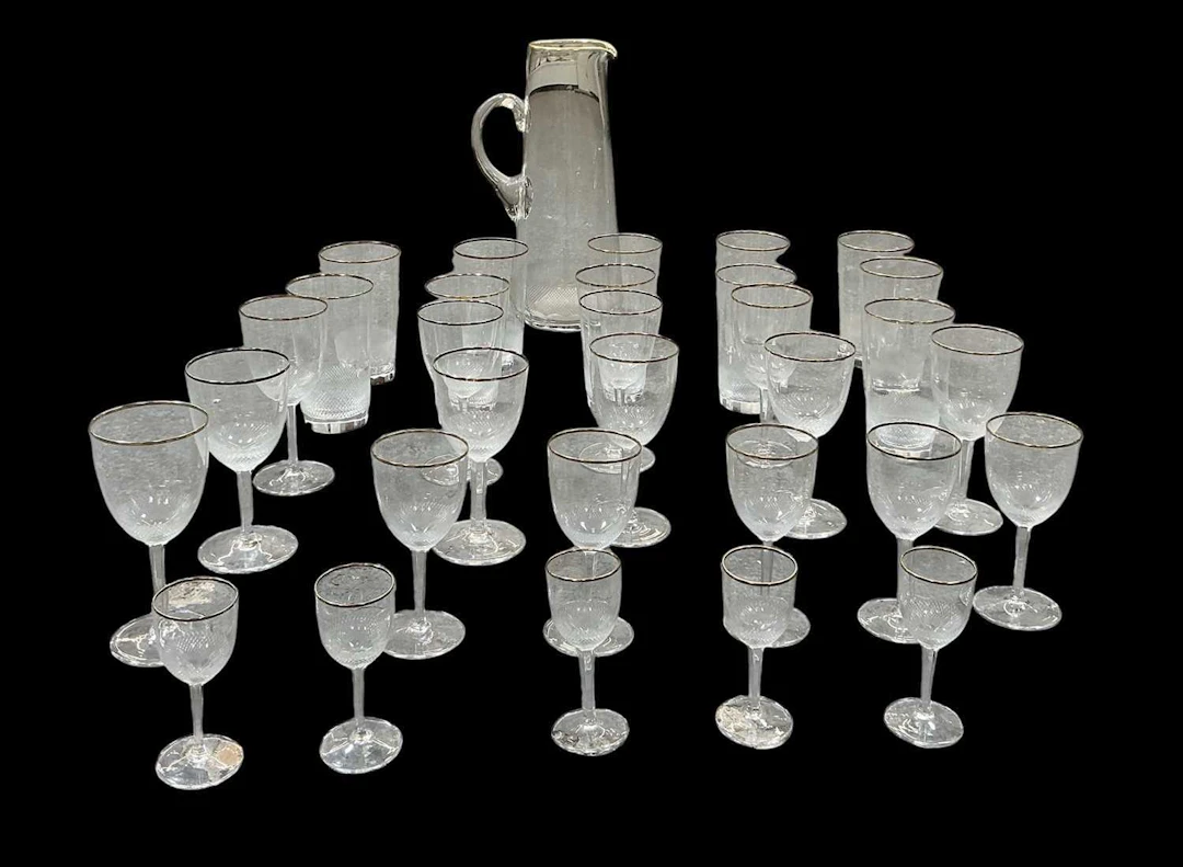 A suite of mid century cut glass with gilt rims