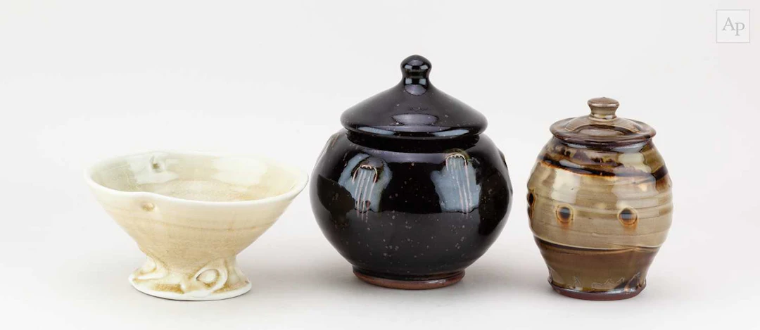 JOHN JELFS (born 1946); a stoneware jar and cover covered...