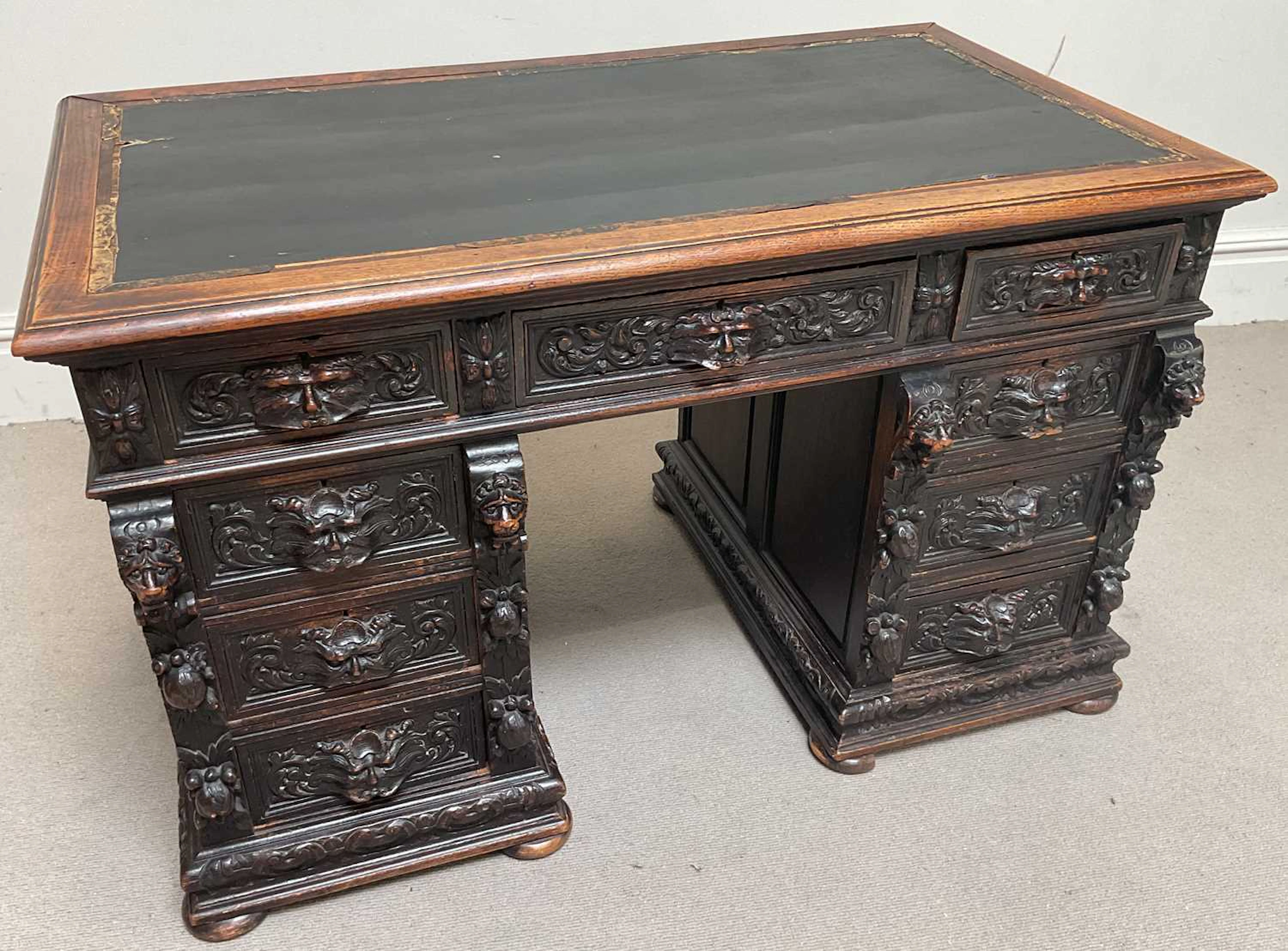 A Victorian carved oak pedestal desk