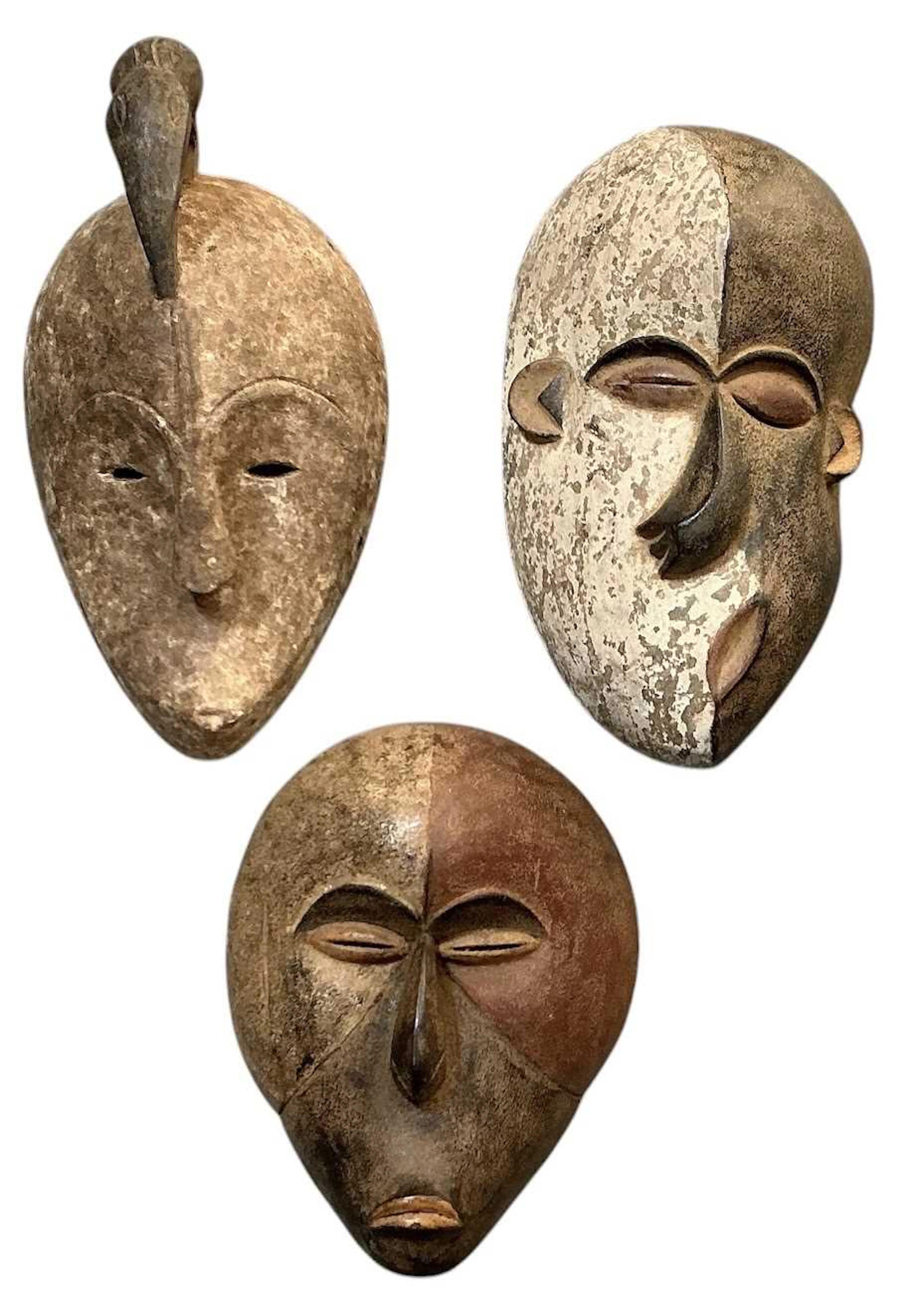 Three African tribal carved wooden and painted masks