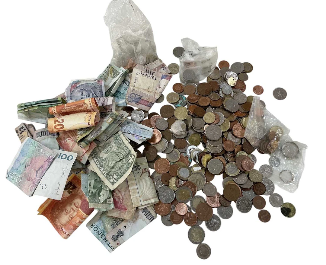 A quantity of assorted all world coins and banknotes