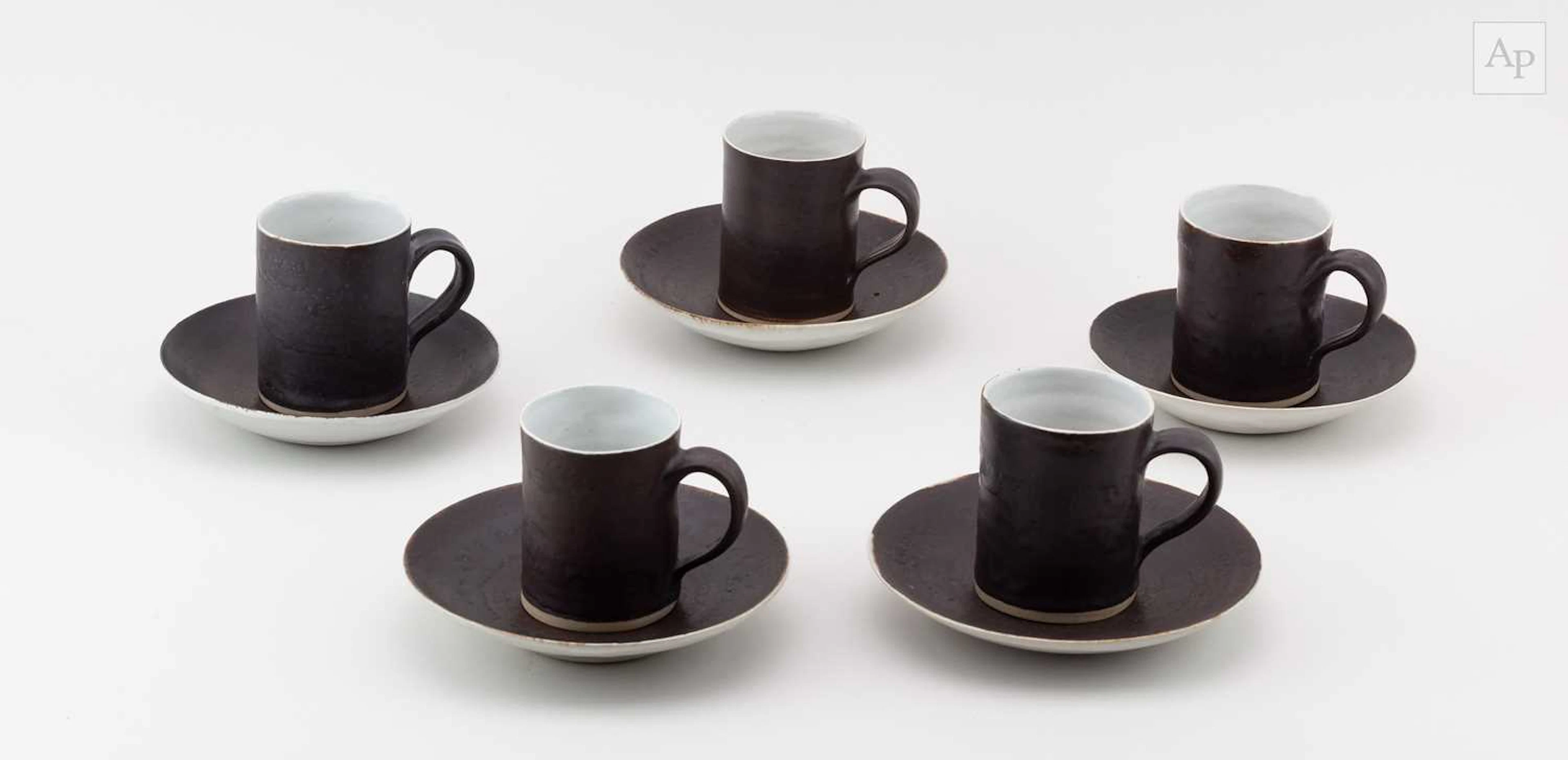 LUCIE RIE (1902-1995); five stoneware cups and saucers...