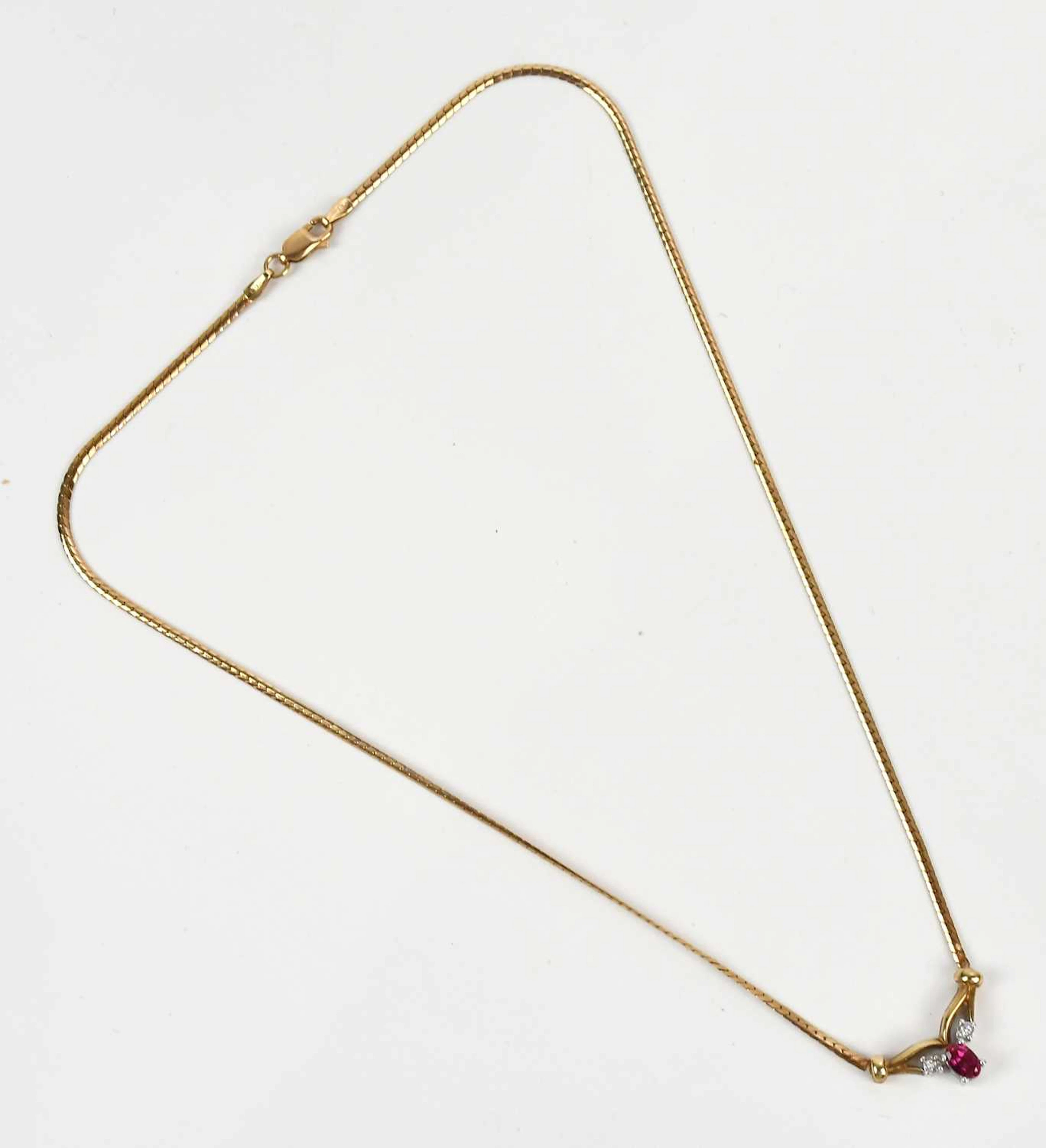 A yellow metal diamond and synthetic ruby set necklace