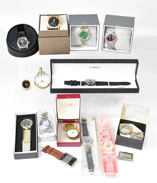 A collection of boxed fashion watches