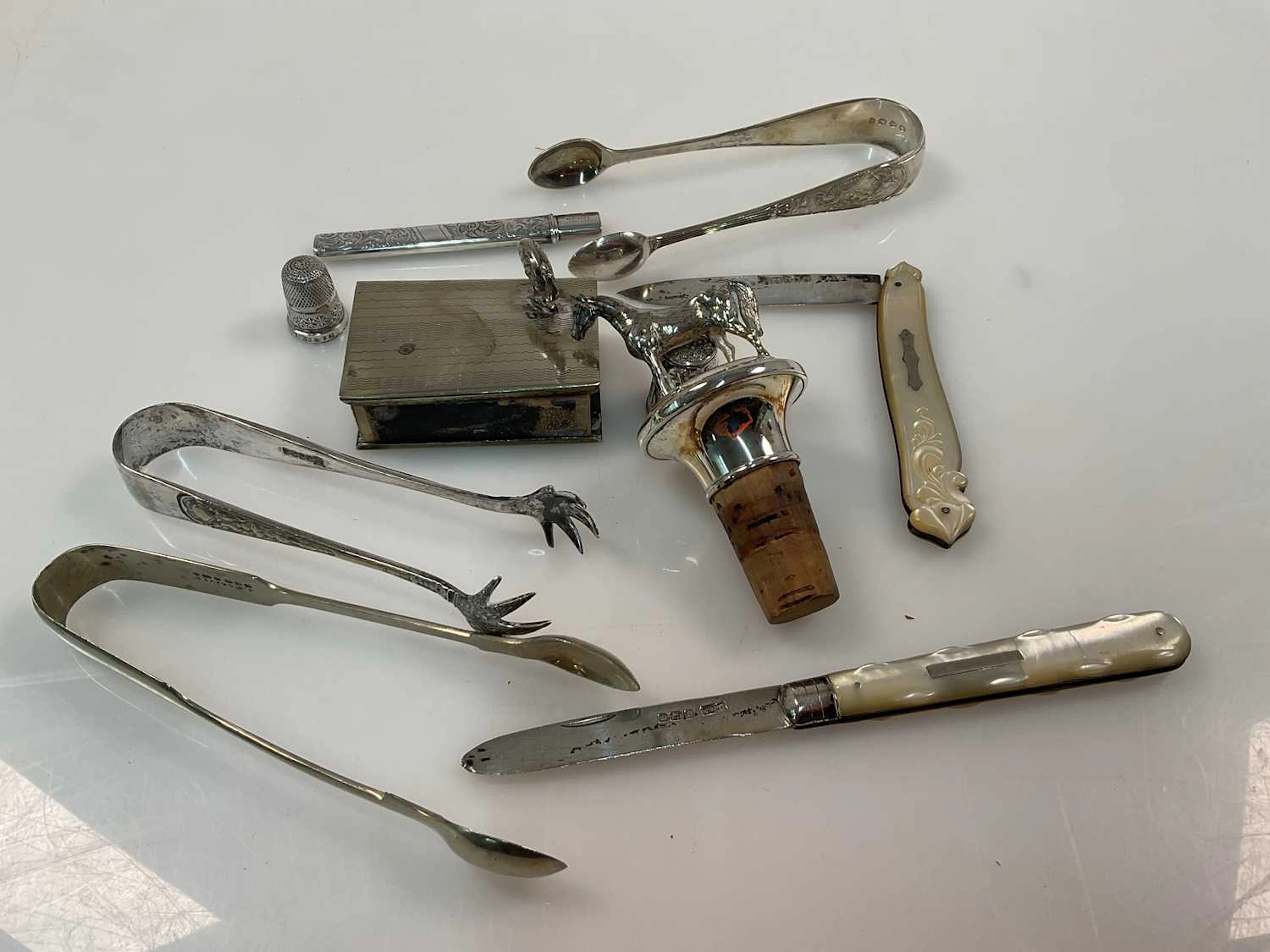 A quantity of hallmarked silver items to include sugar tongs