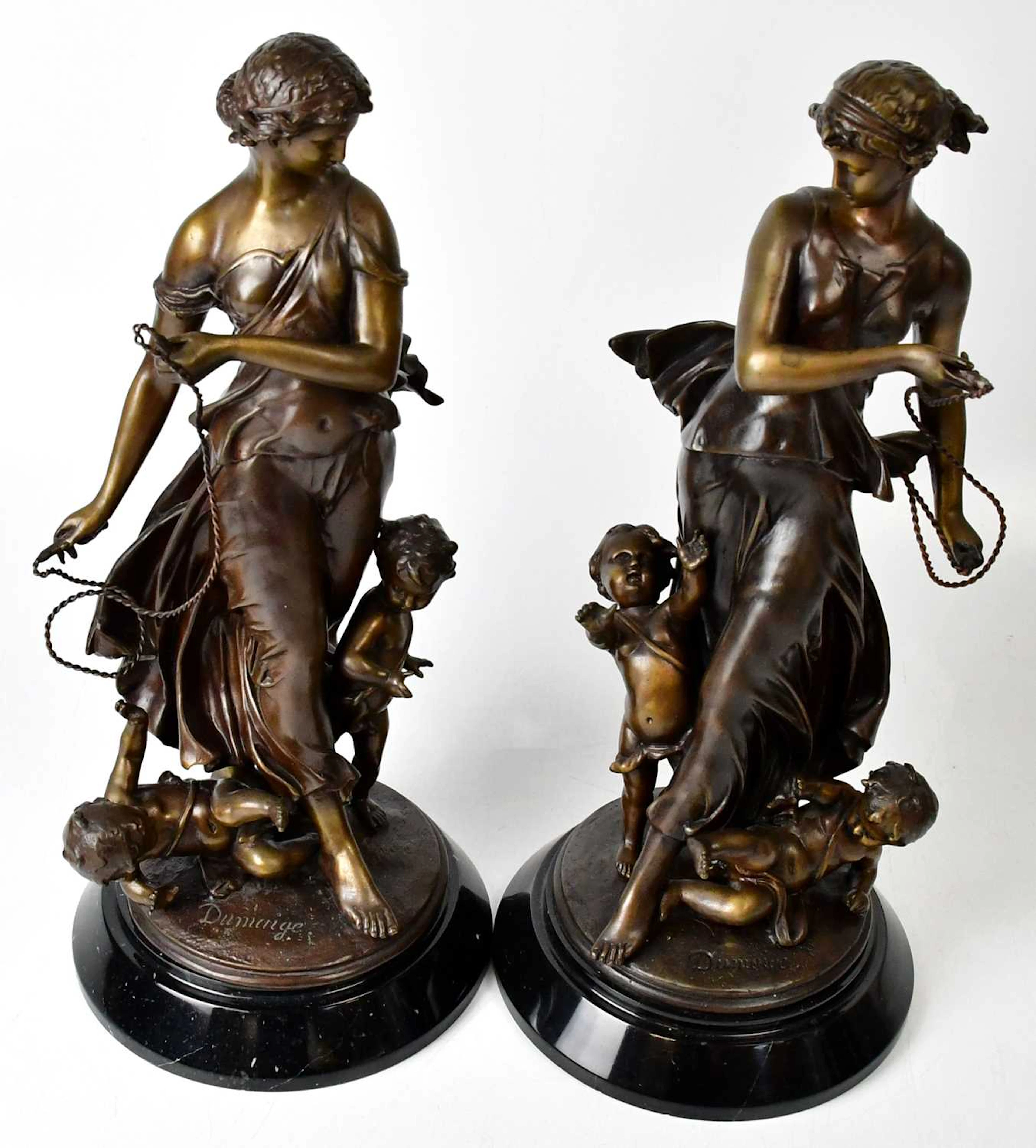 AFTER ETIENNE-HENRI DUMAIGE; a pair of bronze figures