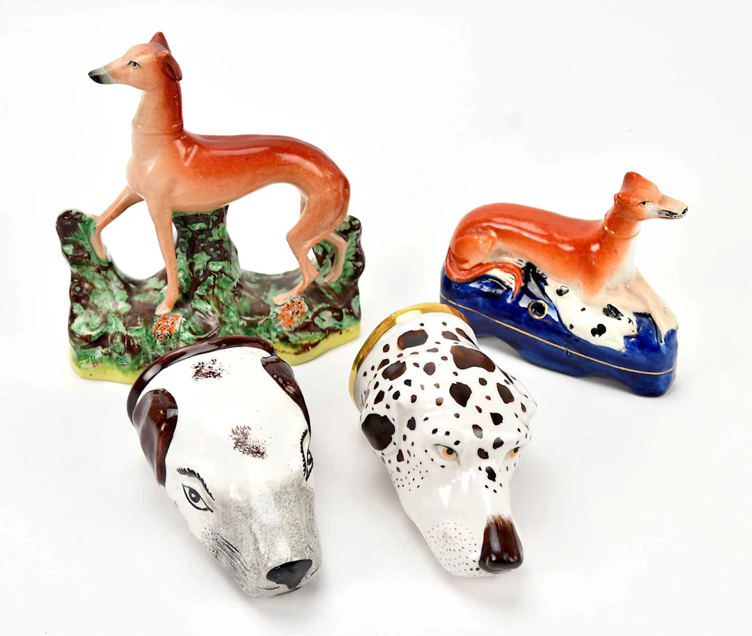 Two 19th century Staffordshire stirrup cups formed as hound heads