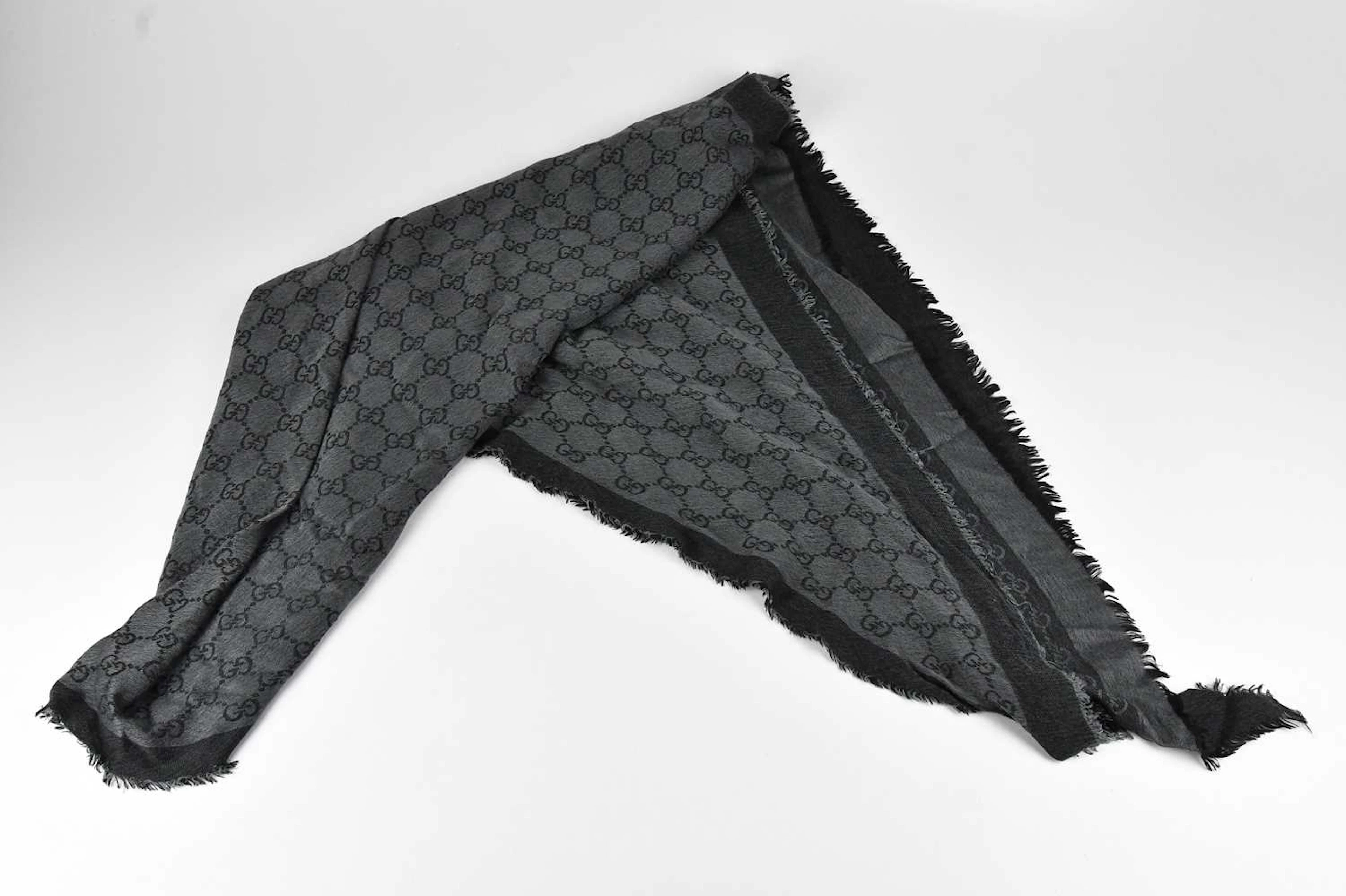 GUCCI; a 100% wool black and grey large triangular scarf...