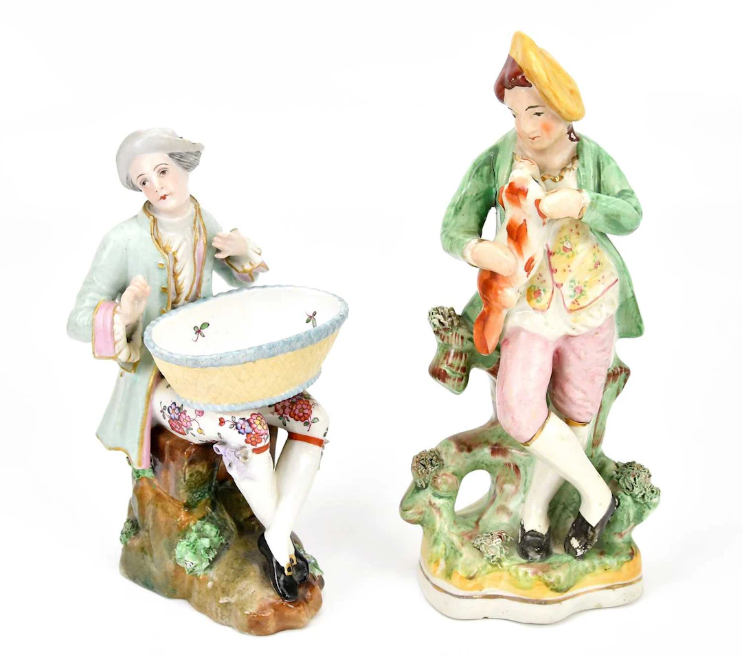 A Continental porcelain figure of seated man with basket