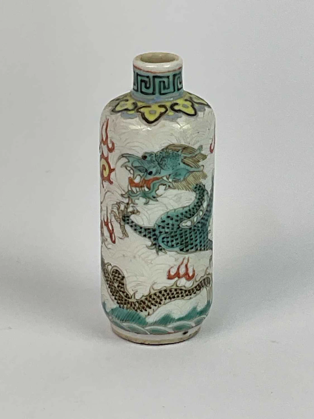 A Chinese porcelain snuff bottle decorated with a Famille Verte style dragon