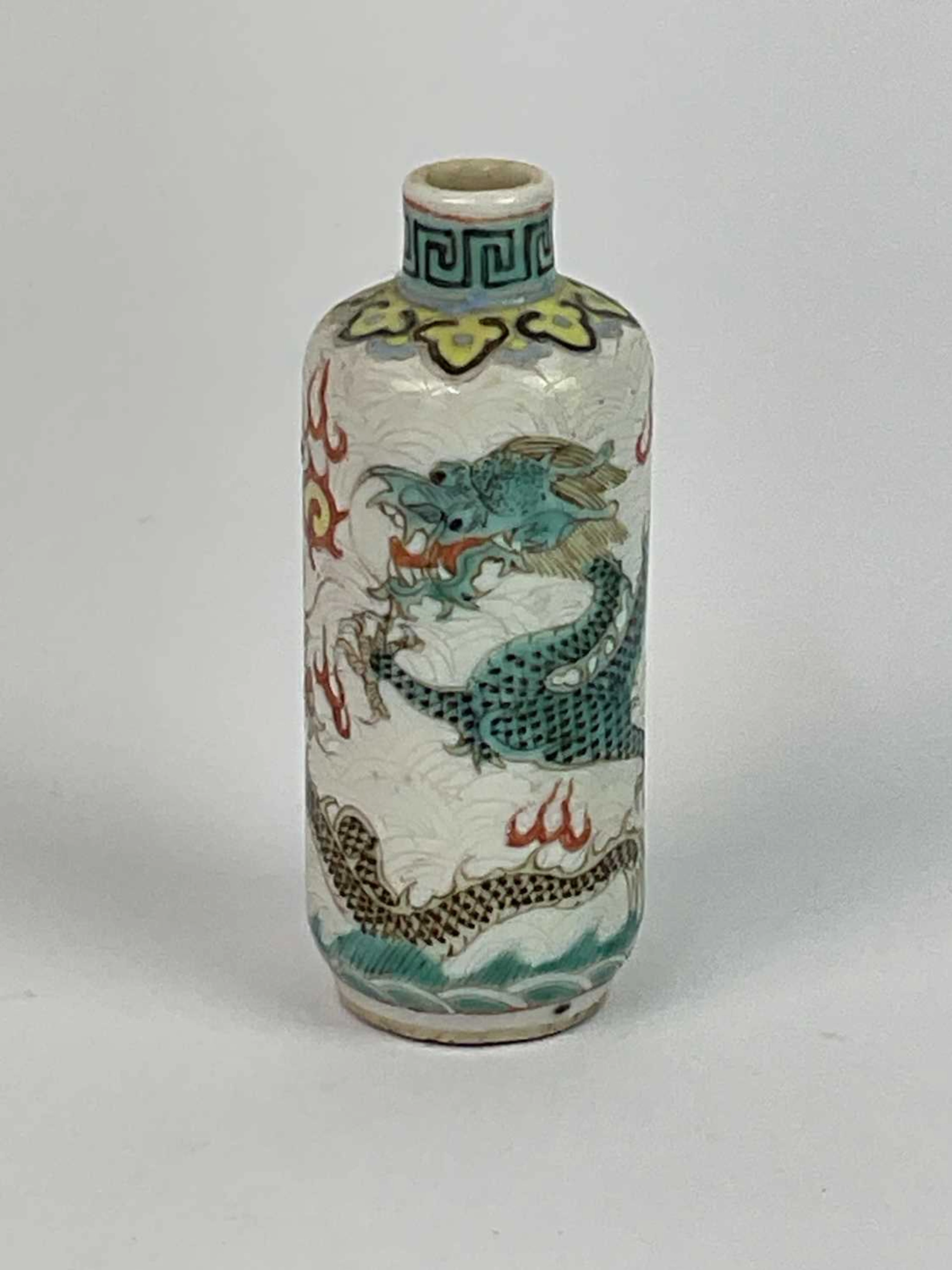 A Chinese porcelain snuff bottle decorated with a Famille Verte style dragon