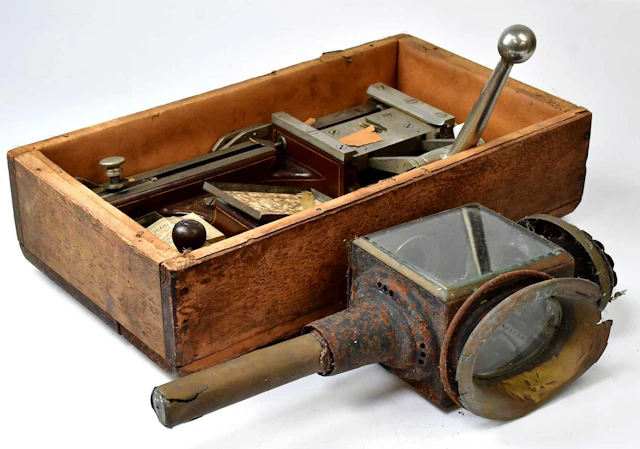 A vintage cigarette rolling machine in a fitted case