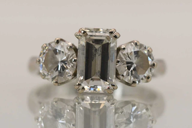 An 18ct white gold three stone diamond set ring