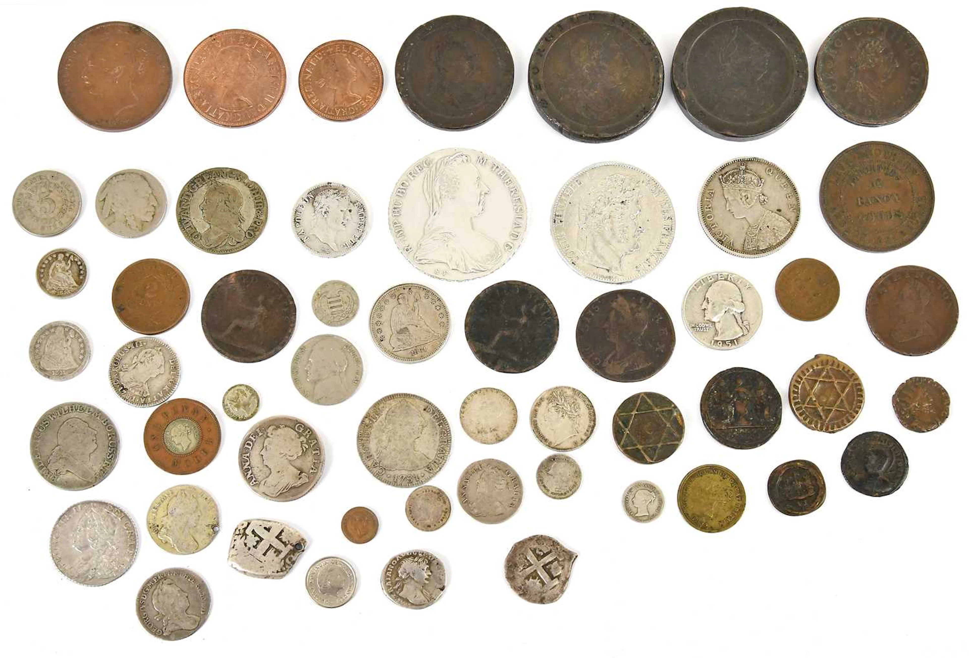 A collection of mixed coins including Spanish