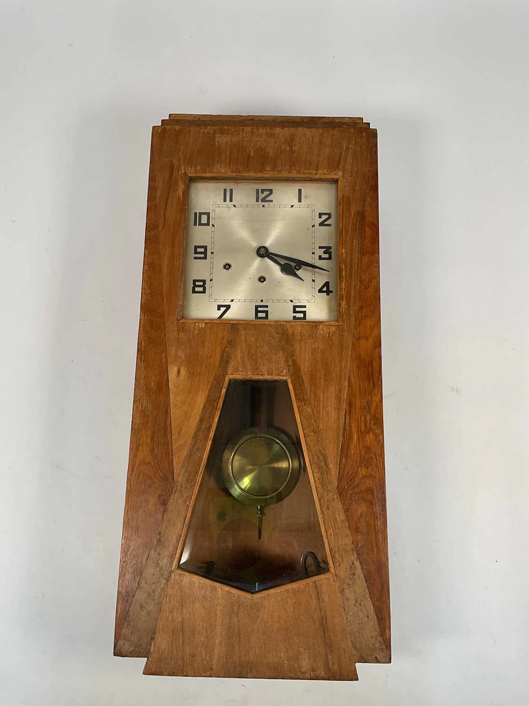 An Art Deco pine surround wall clock