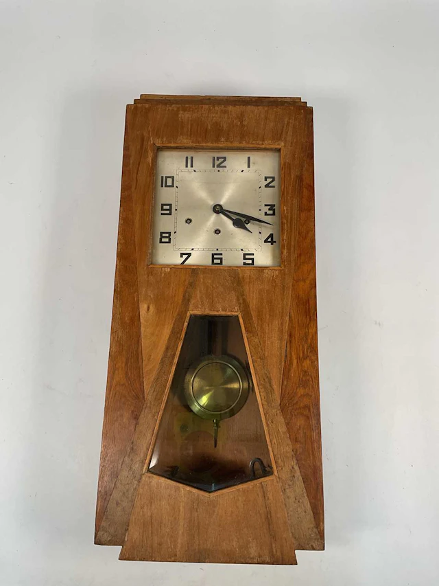 An Art Deco pine surround wall clock