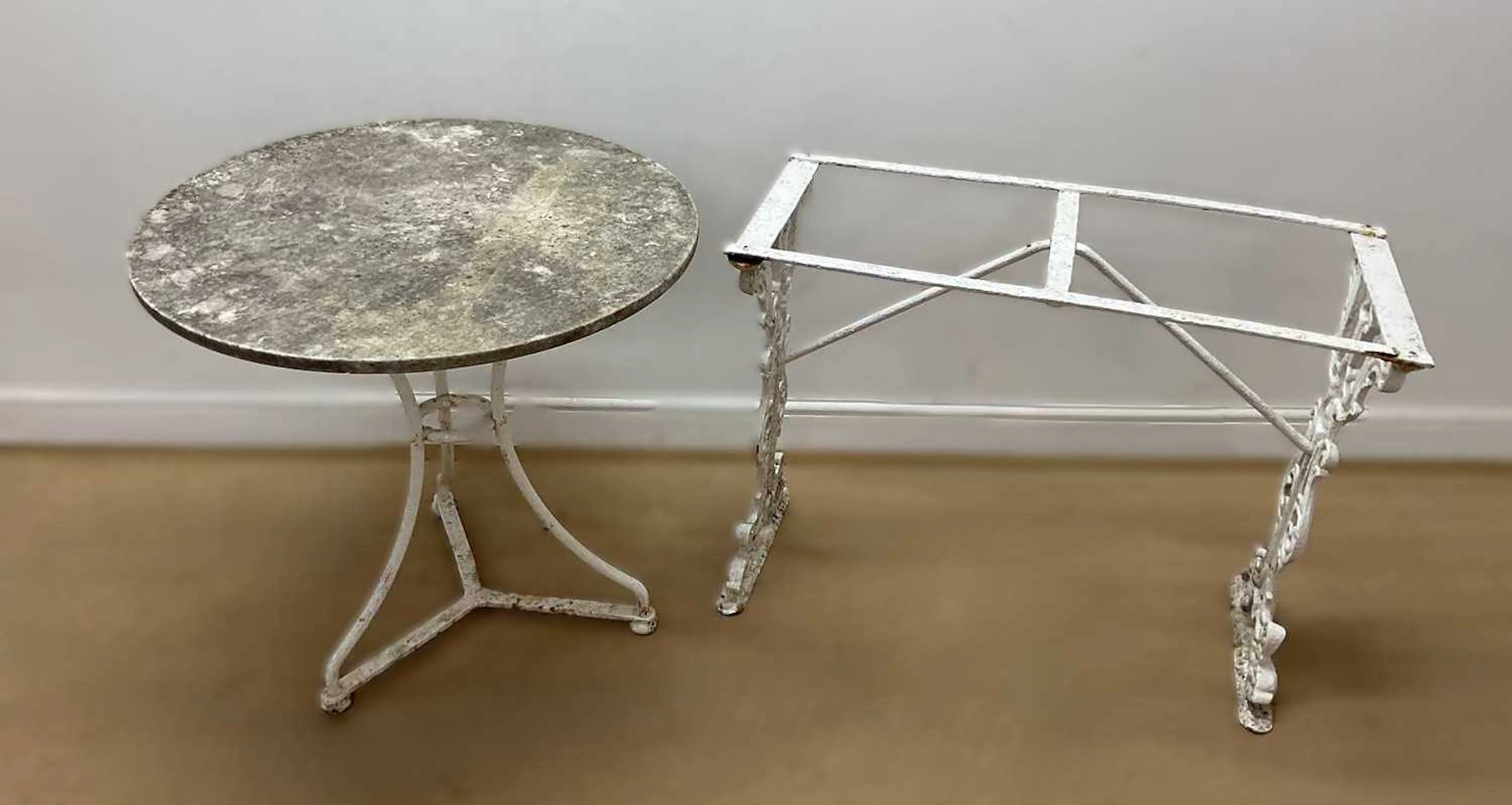 An early 20th century cast iron granite topped circular garden table