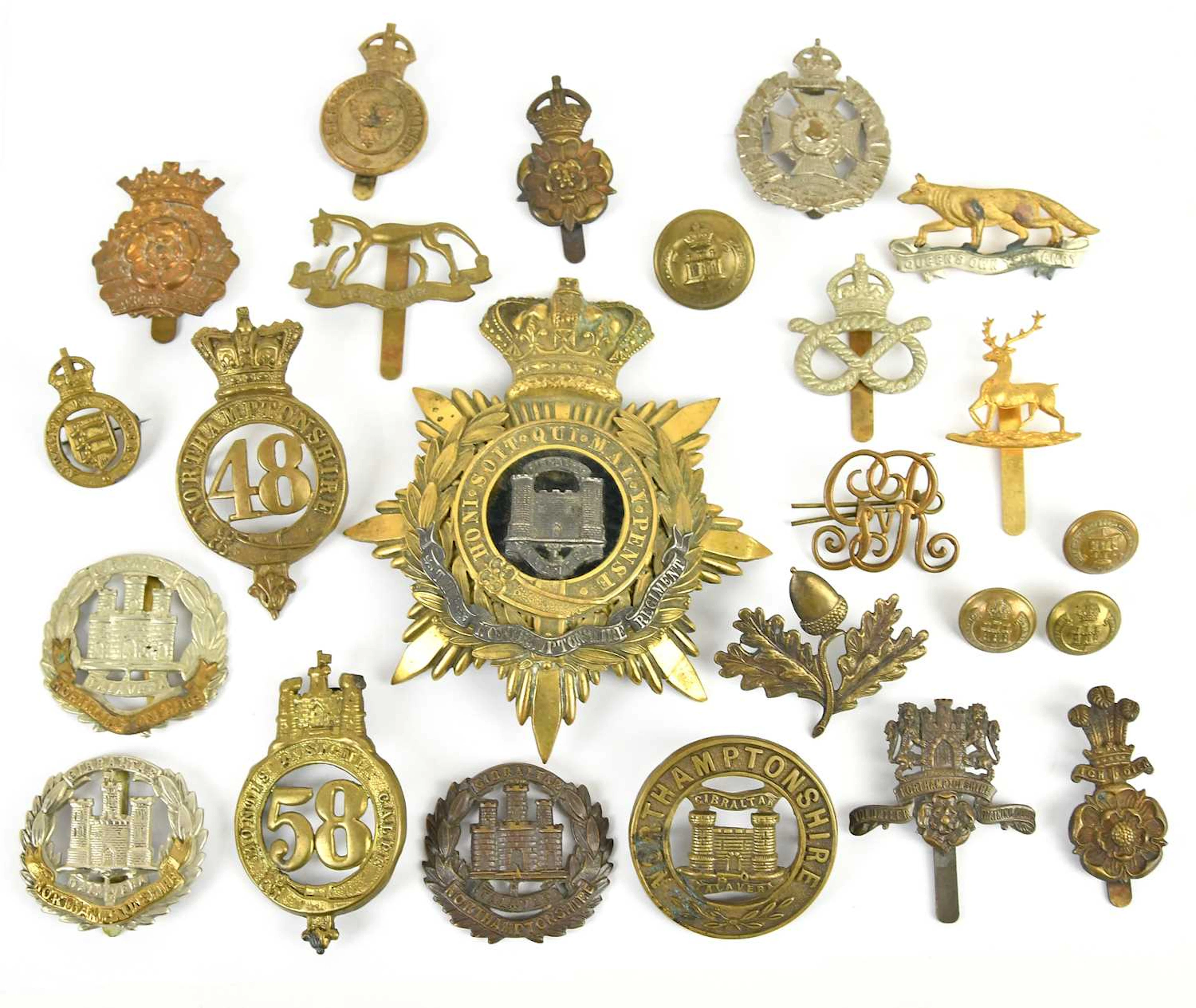 A good and large collection of military cap badges including Northamptonshire