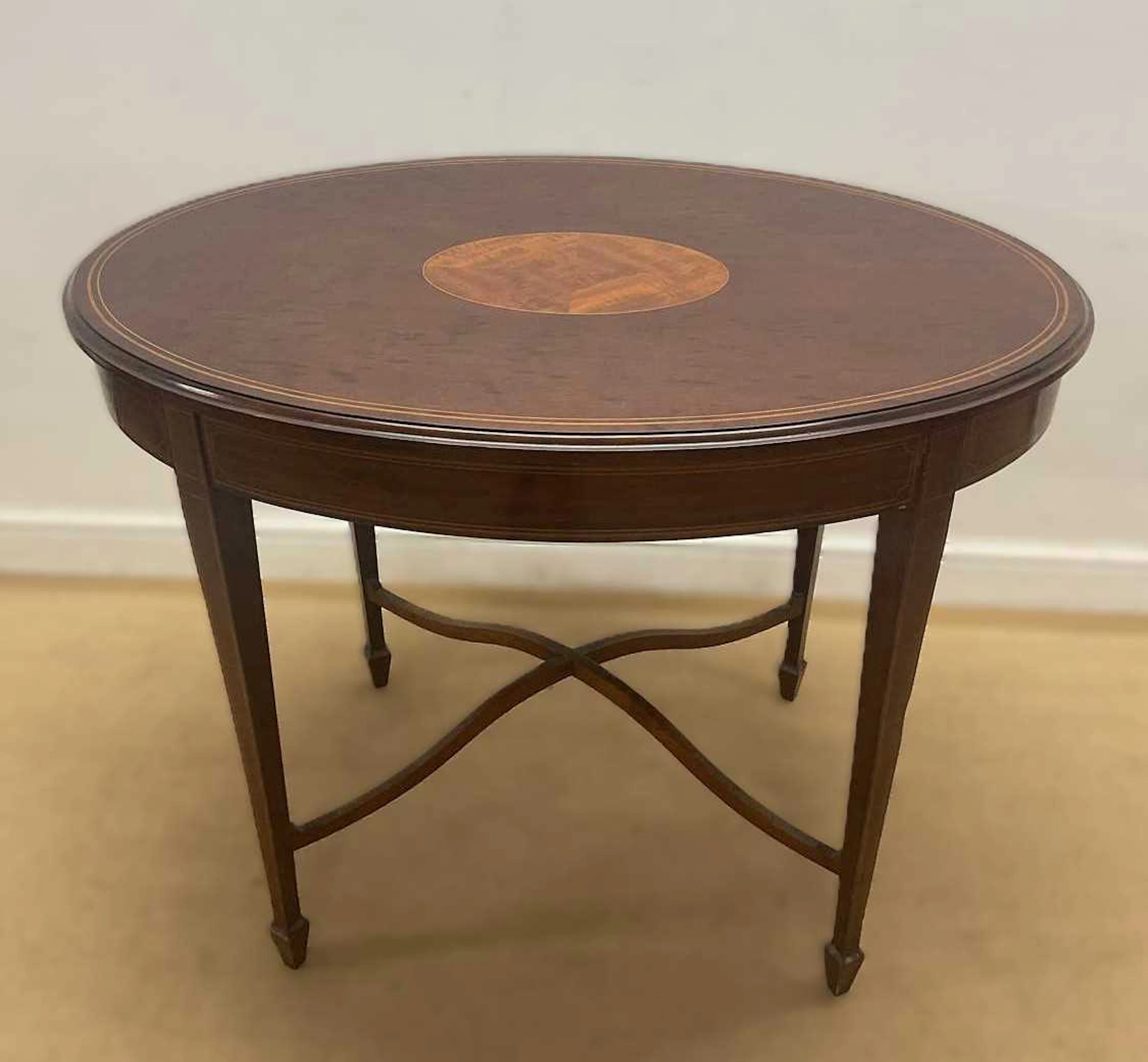 A mahogany and inlaid oval table