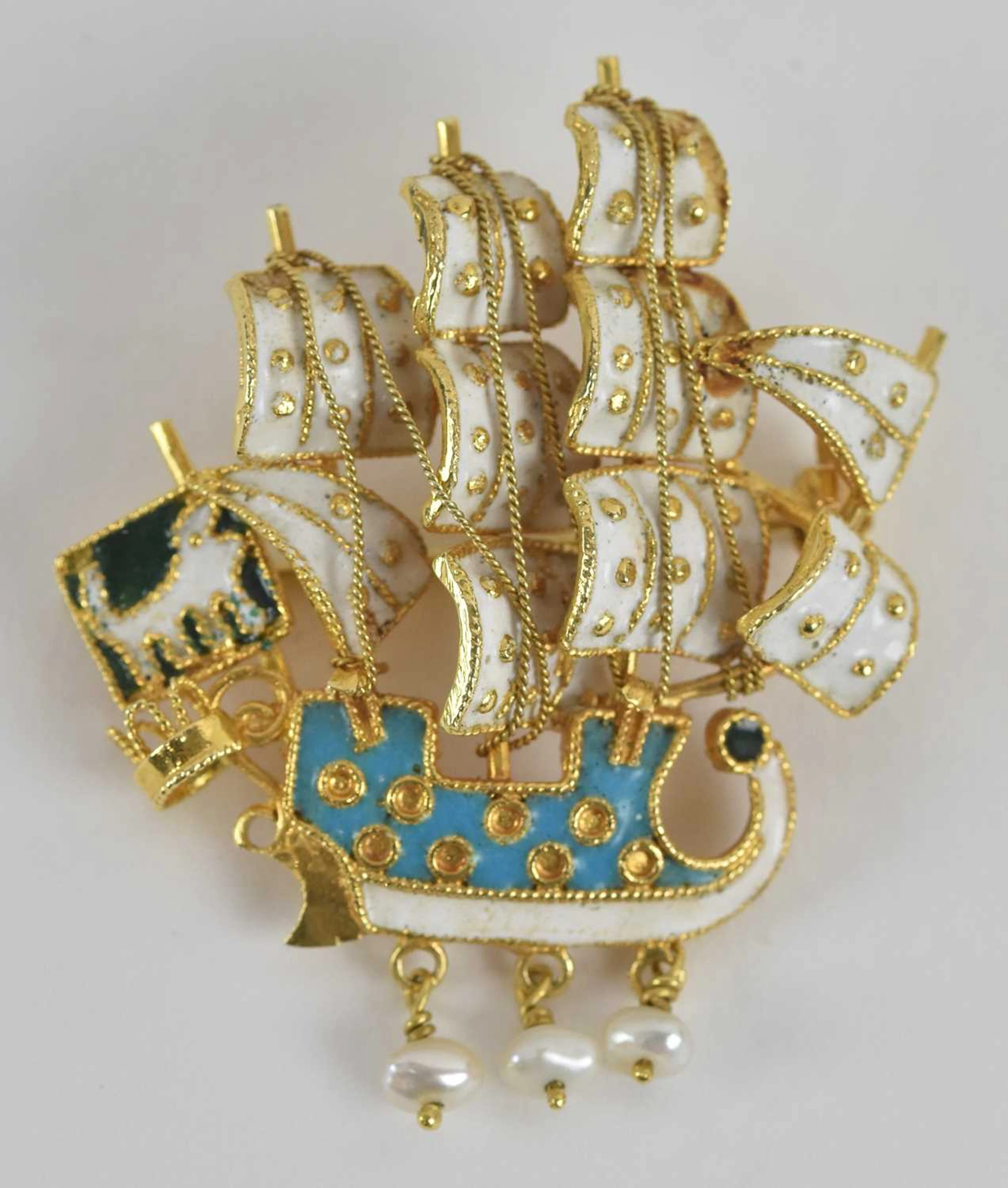 A yellow metal enamelled brooch modelled as a sailing boat