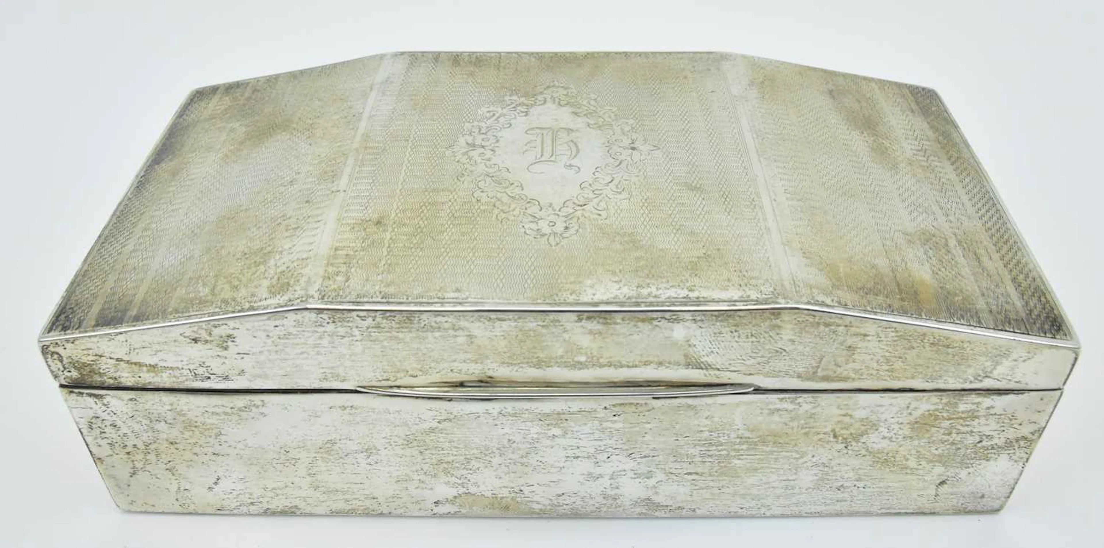 An early 20th century hallmarked silver desktop cigarette box