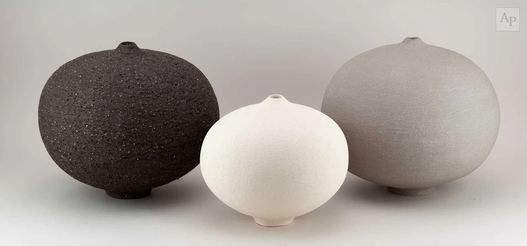 RACHEL PETERS; a graduated trio of grey and black...