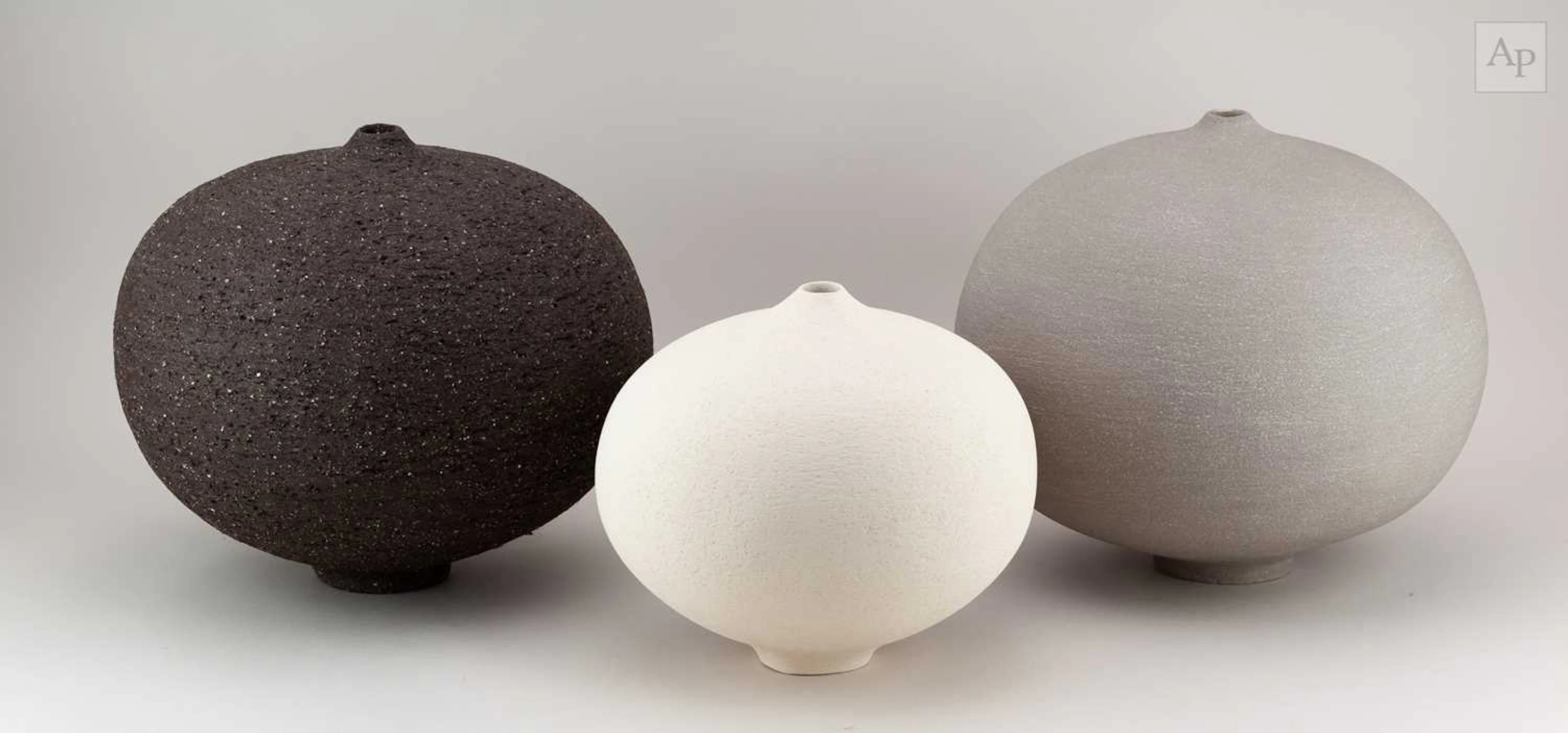 RACHEL PETERS; a graduated trio of grey and black...