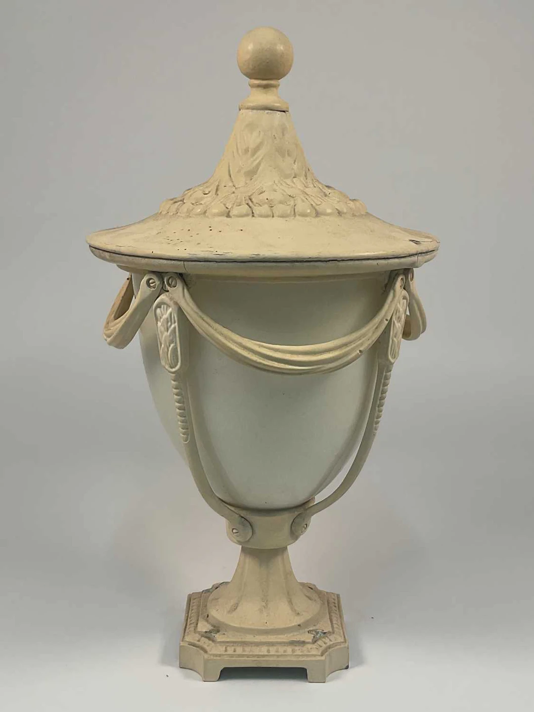 A neoclassical exterior light in the form of an urn with...