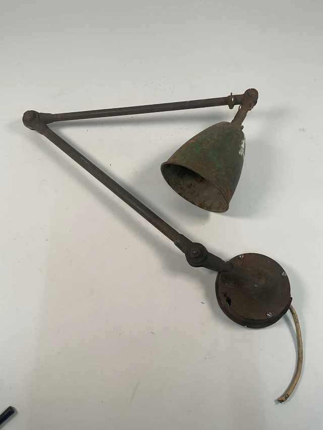A vintage industrial machinist's articulated work lamp with green enamel shade
