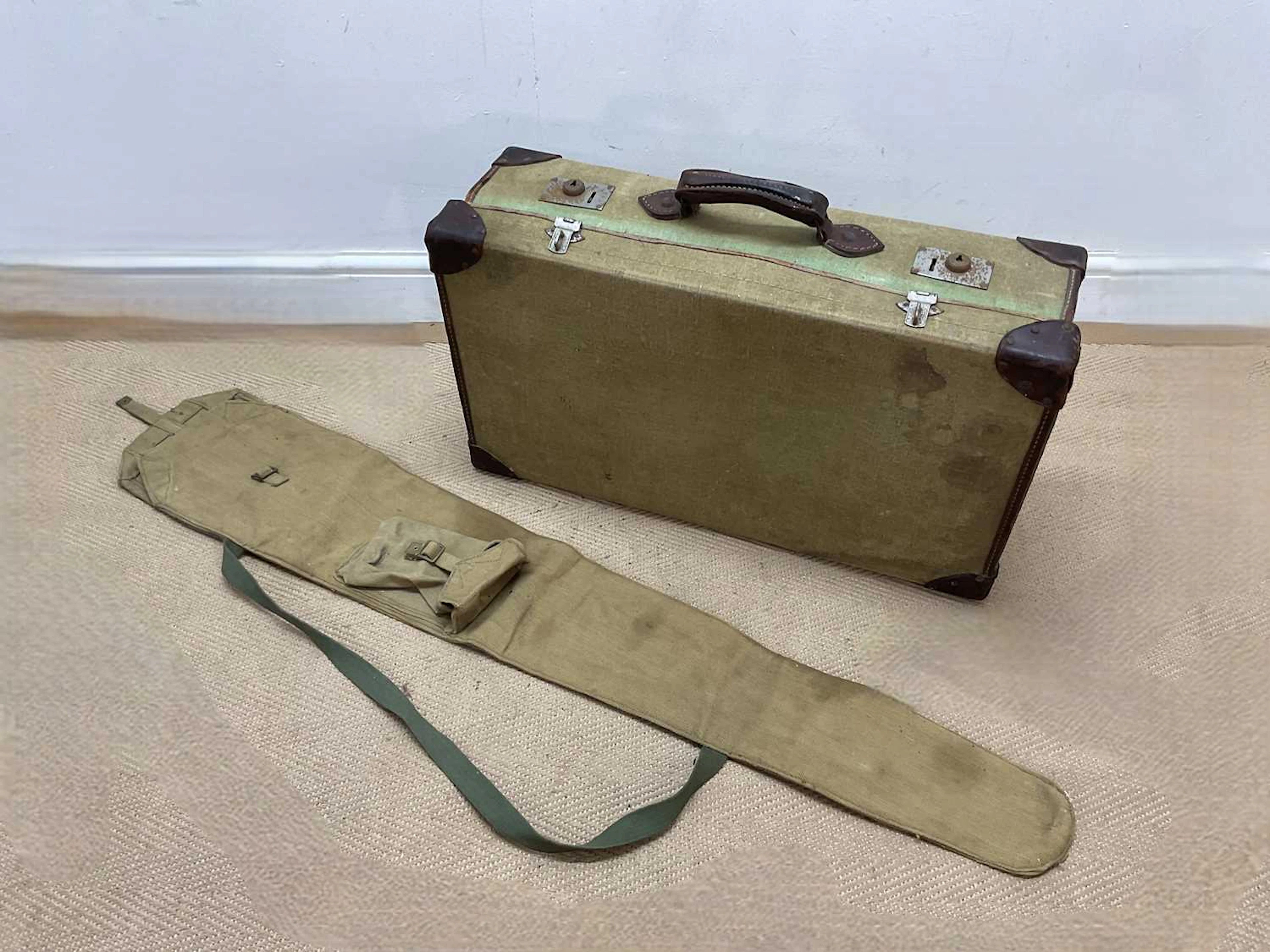 A 1940s British military suitcase together with an American canvas gun case