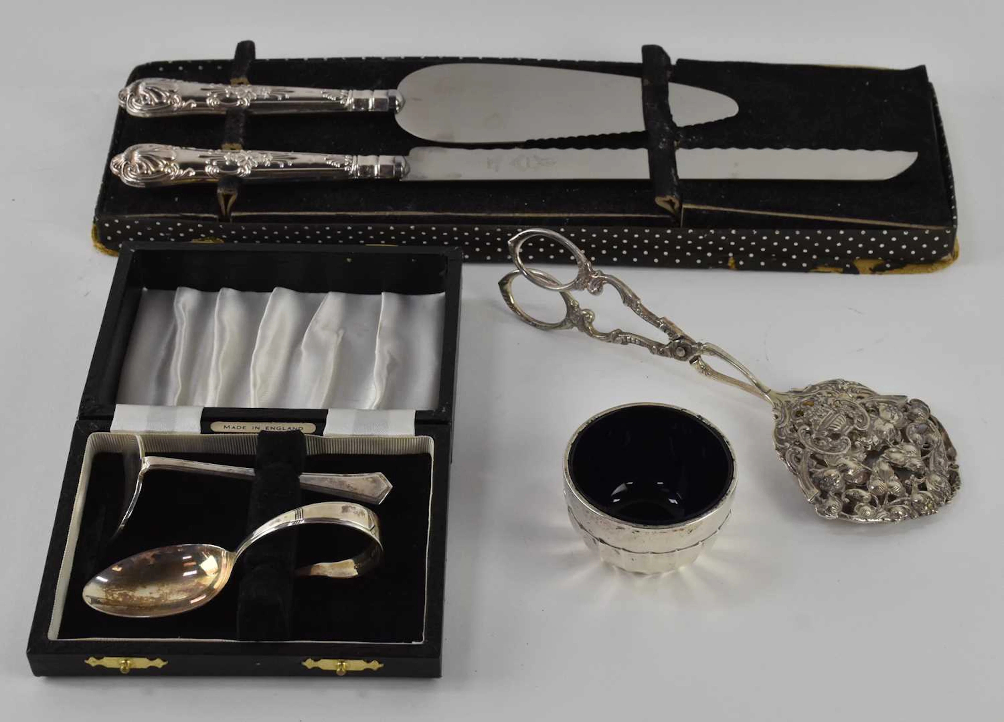 A cased Elizabeth II hallmarked silver baby feeding spoon and food pusher