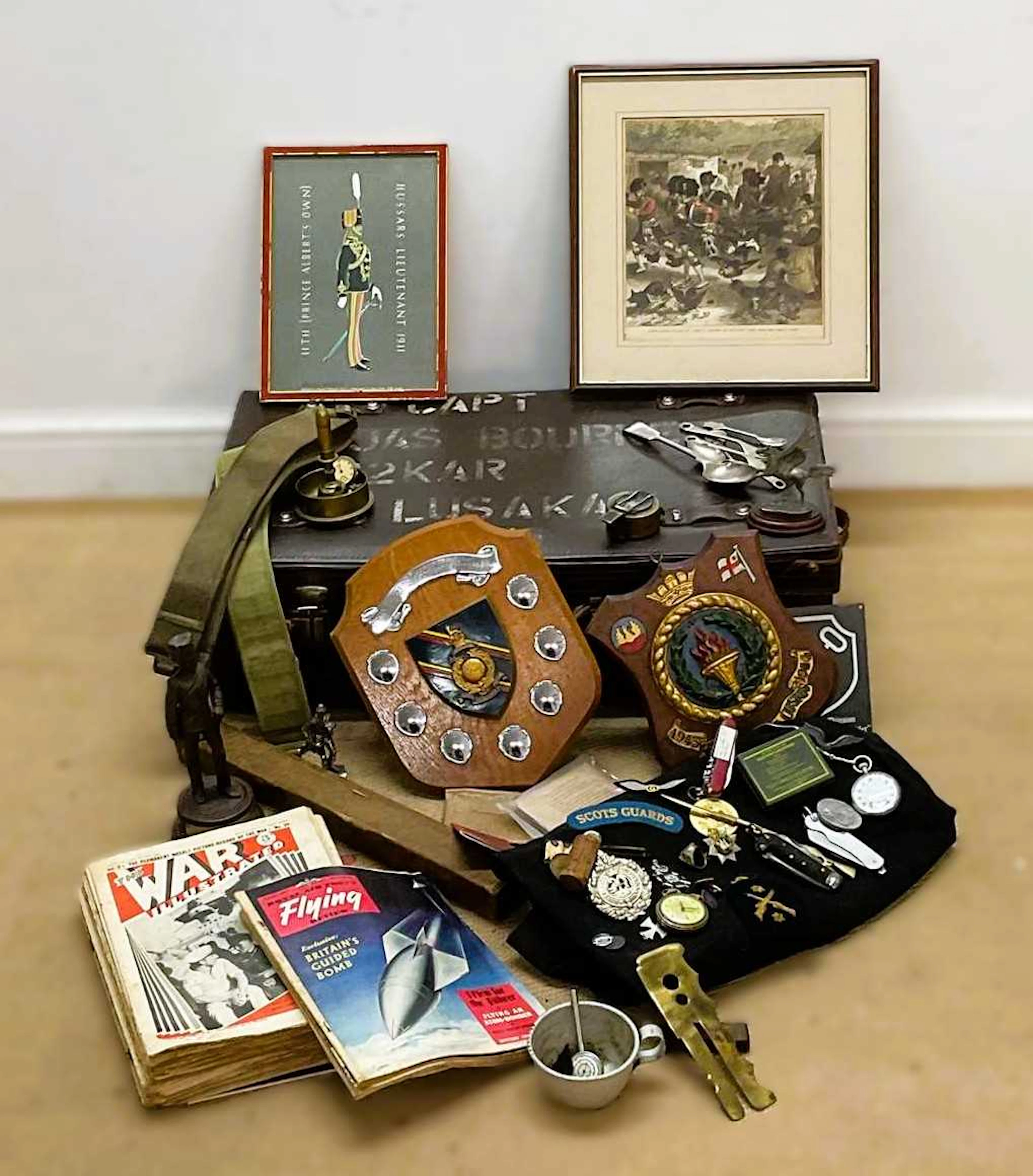 A military leather officer's case containing a quantity of military items