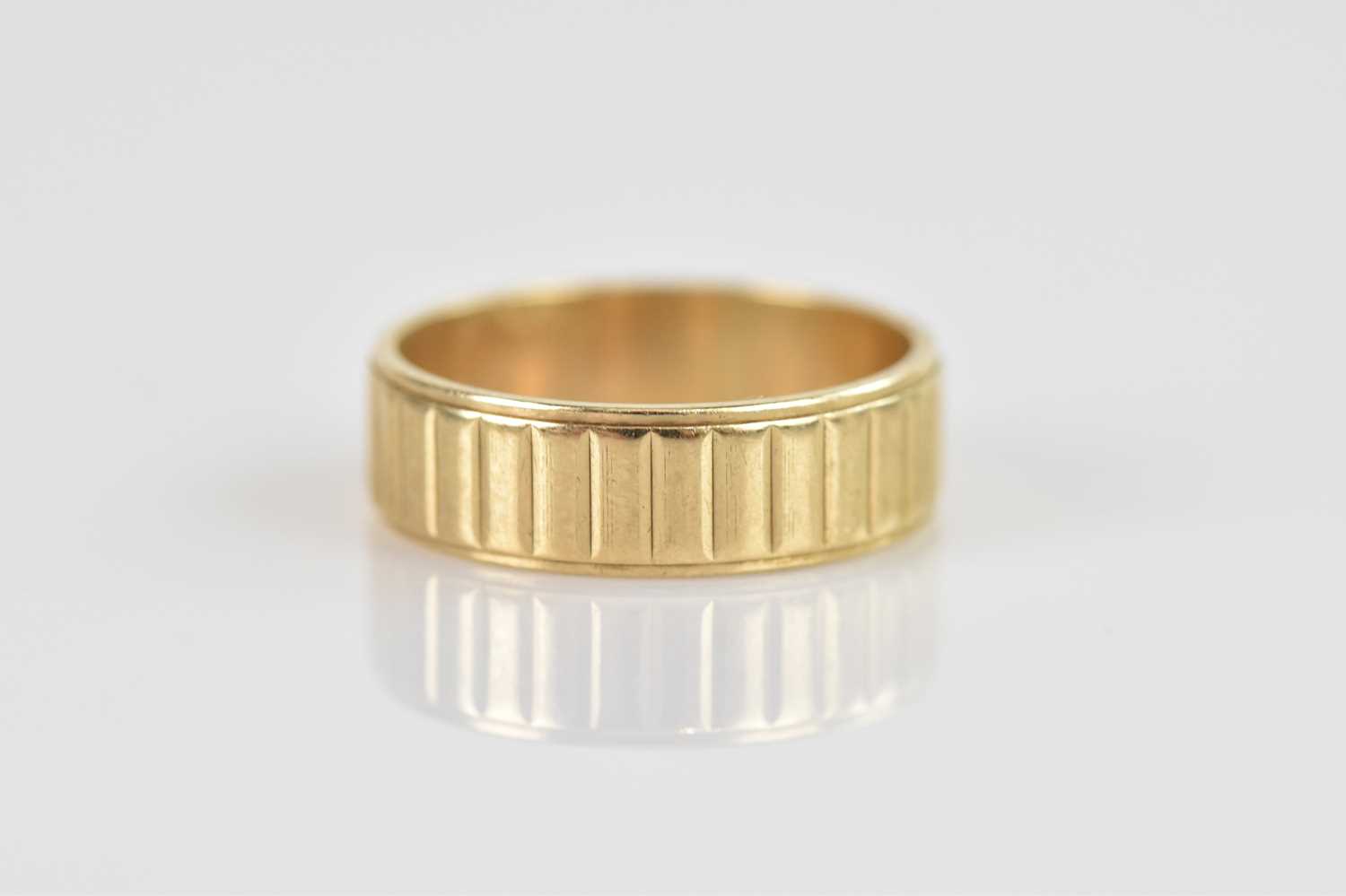 A 9ct textured yellow gold wedding band