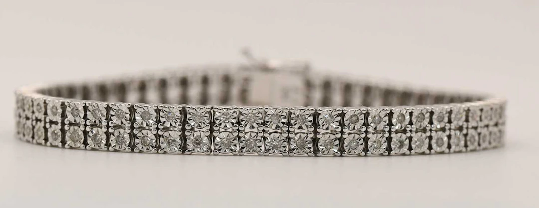 A 9ct white gold double line diamond bracelet
