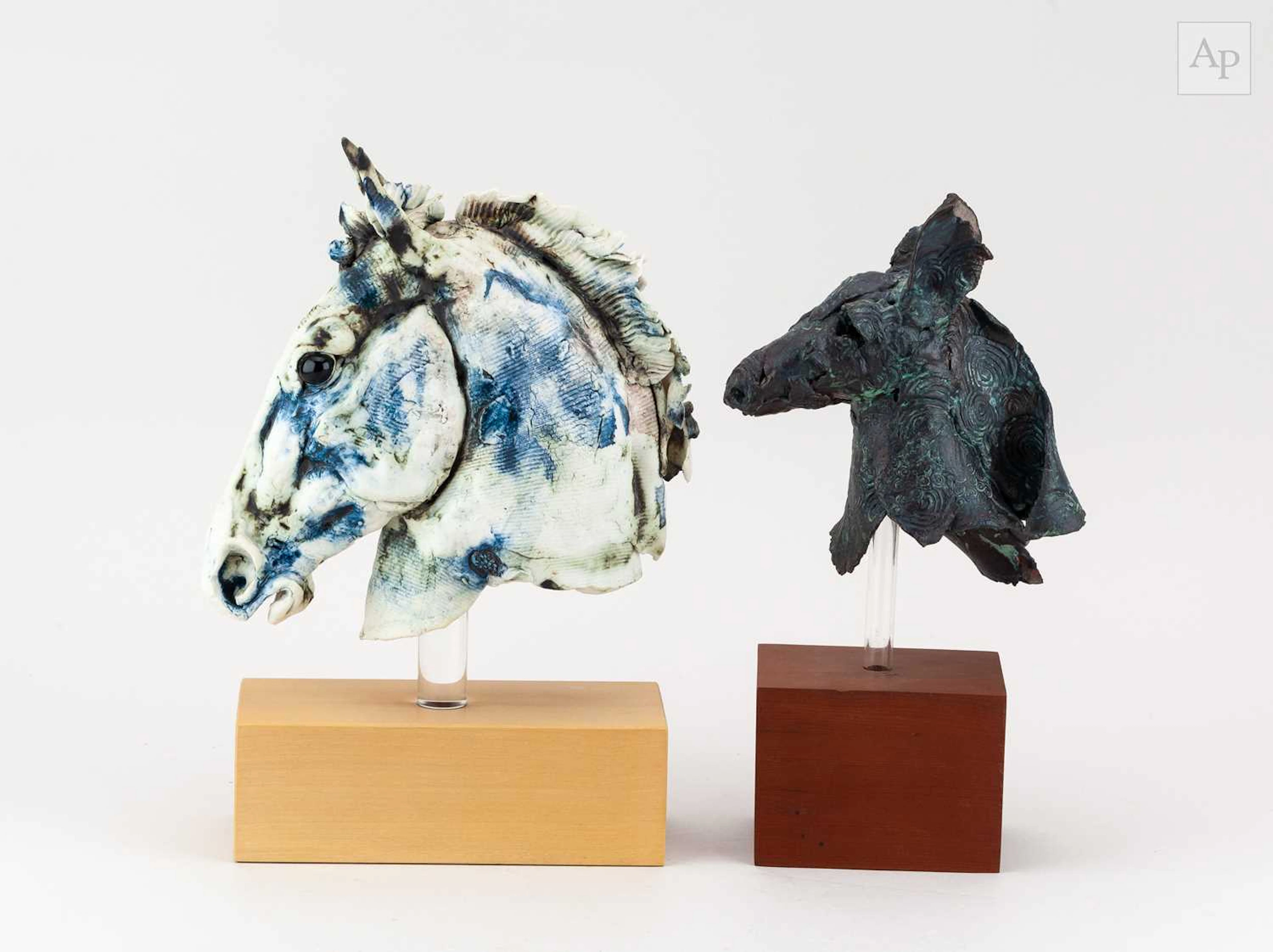 A porcelain sculpture of a horse's head with cobalt...