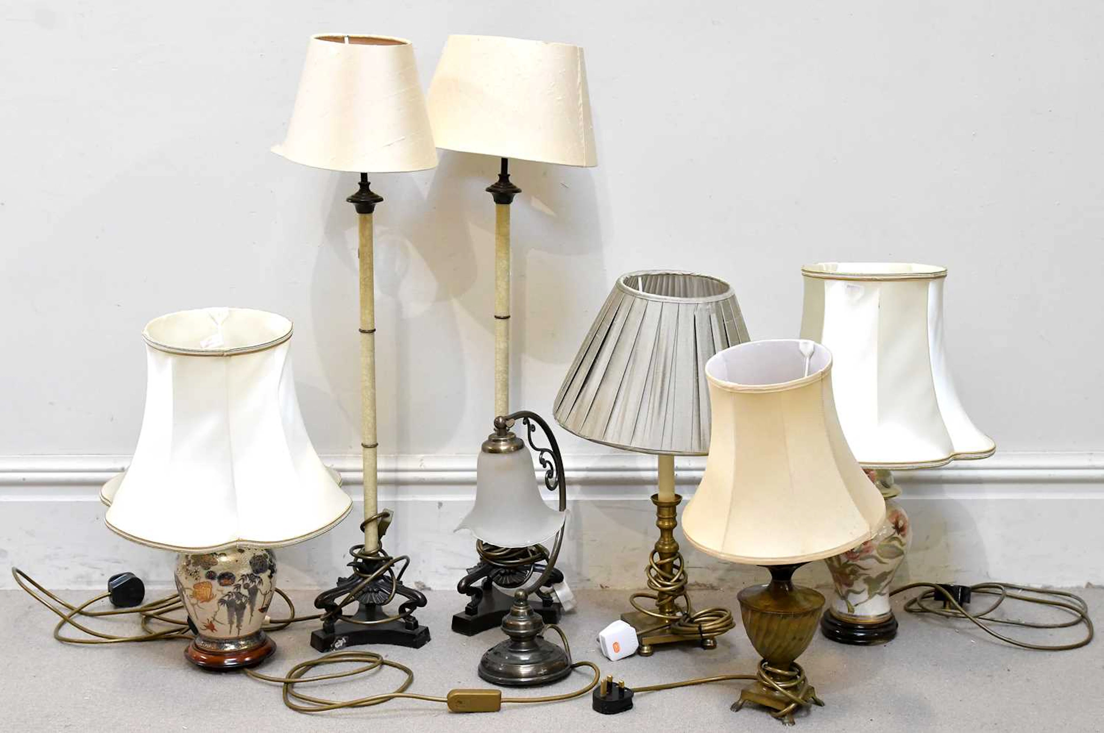 A collection of seven modern table lamps
