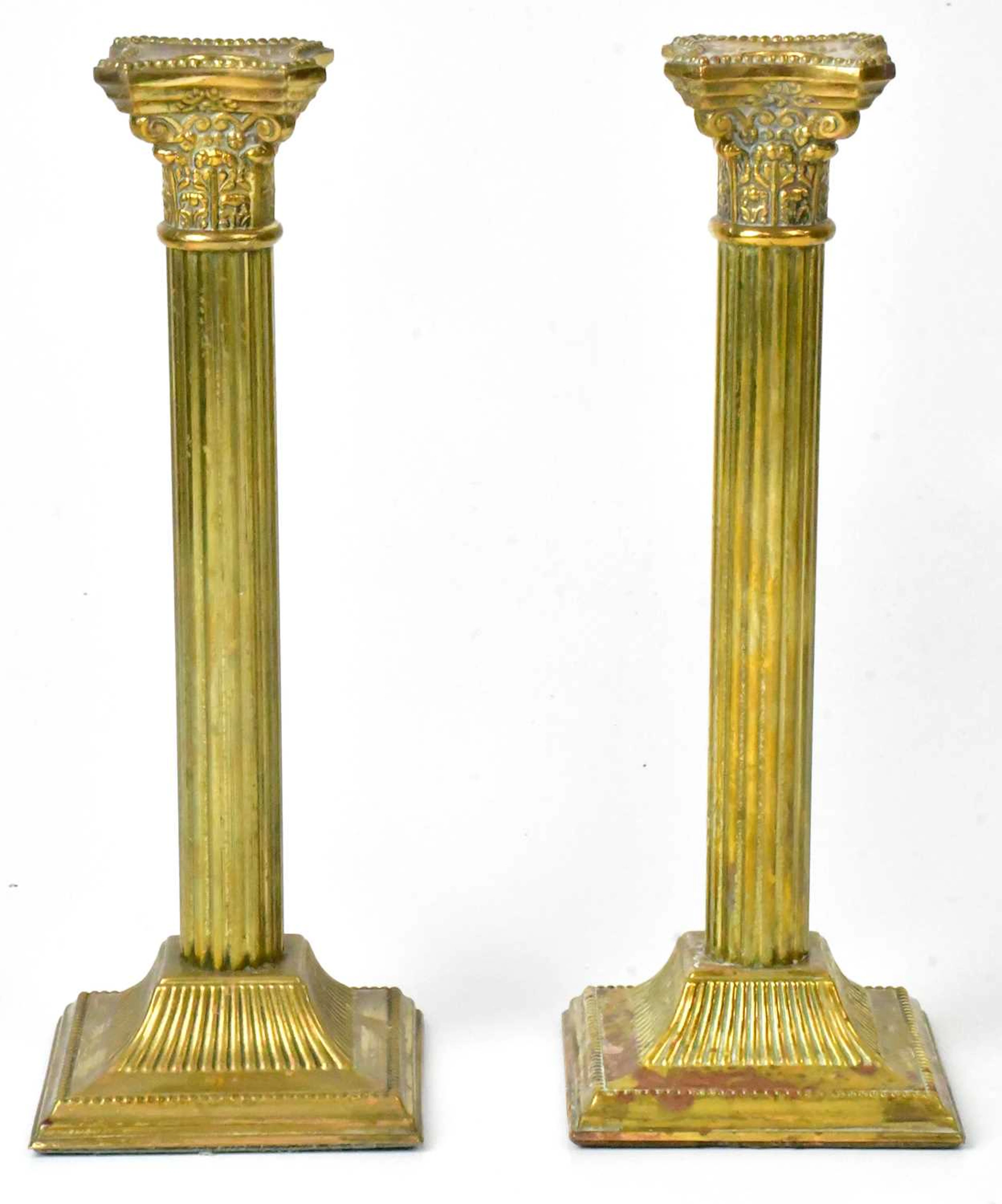 A pair of brass Corinthian column form candlesticks