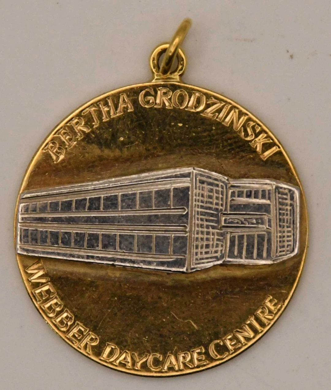 A 9ct yellow and white gold circular pendant/medallion