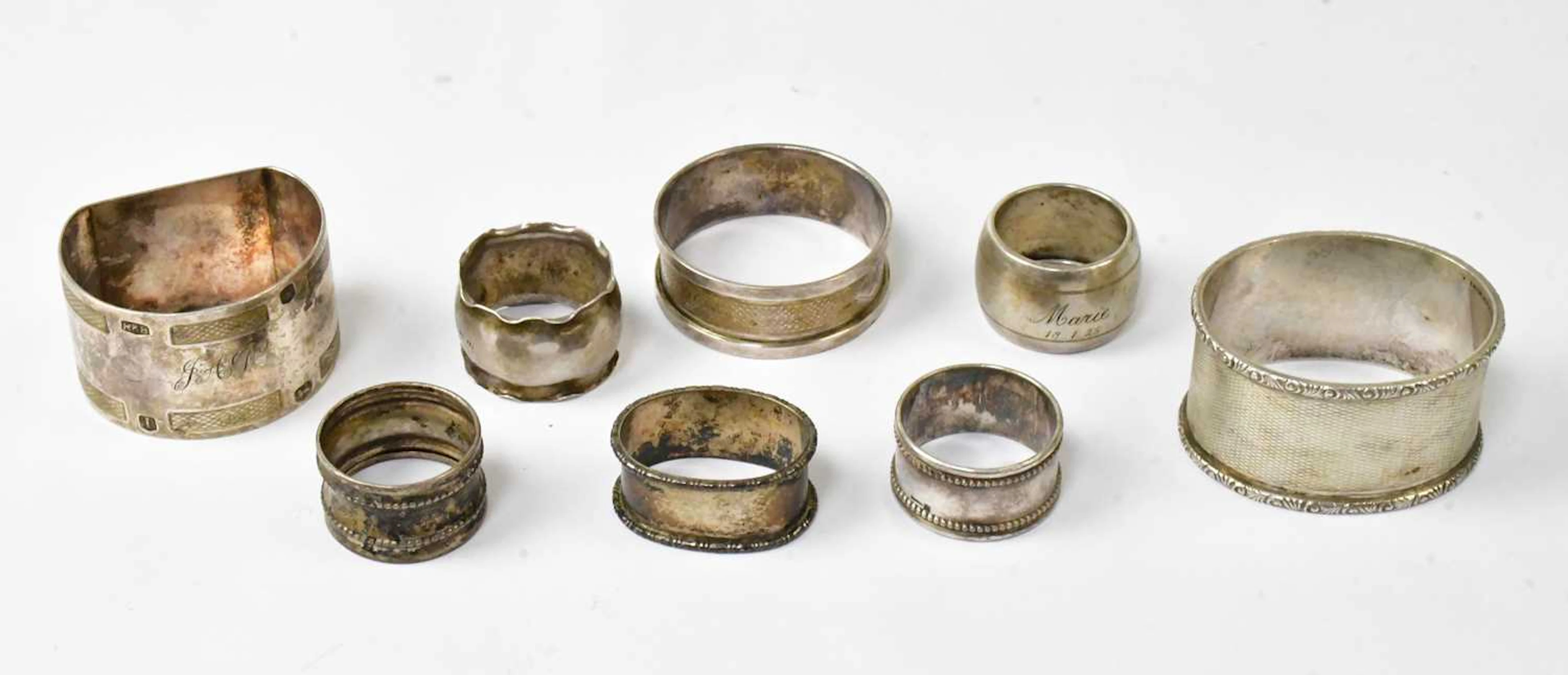 Three hallmarked silver napkin rings various dates and makers