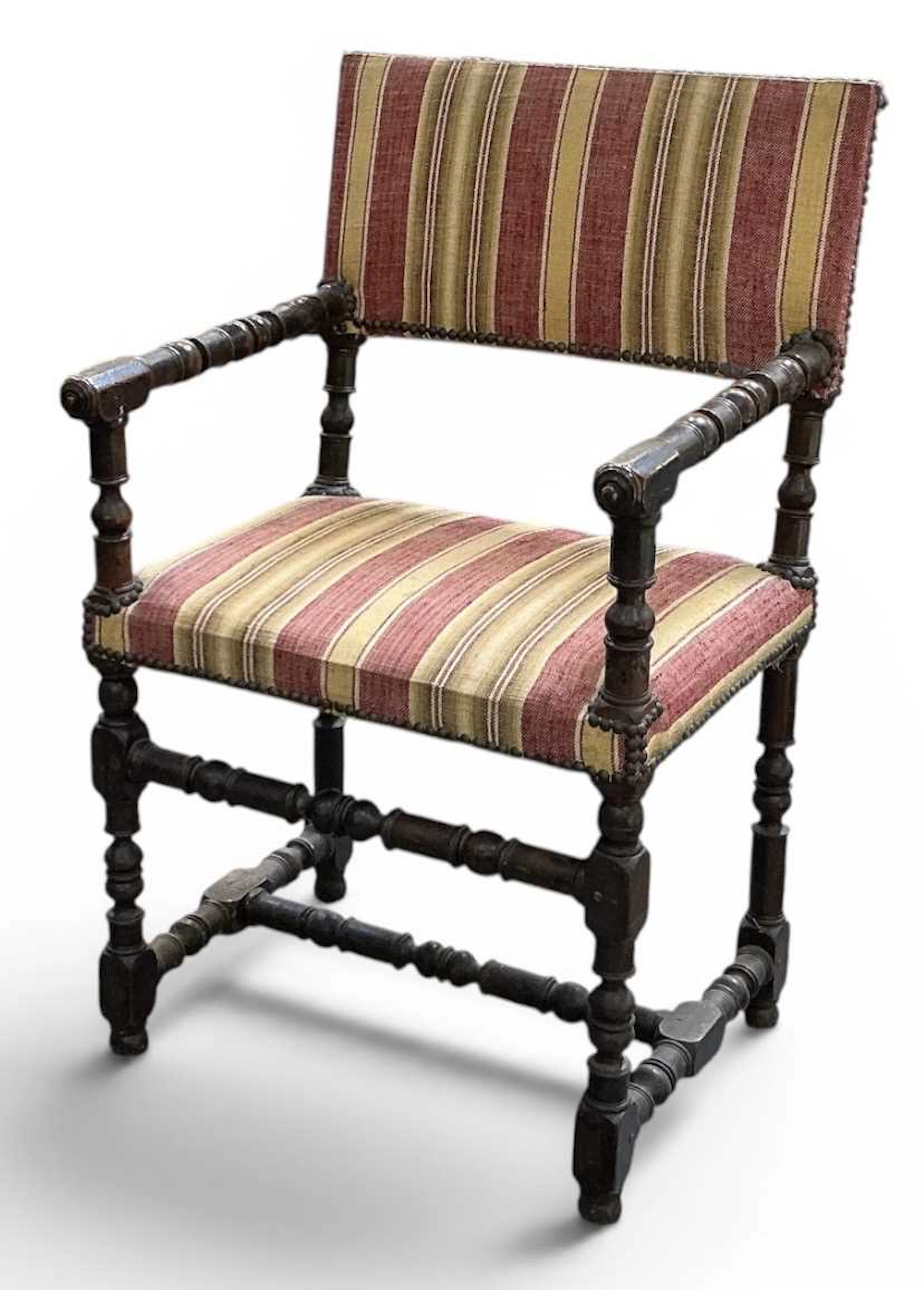 A French Louis XIII mahogany framed open arm elbow chair