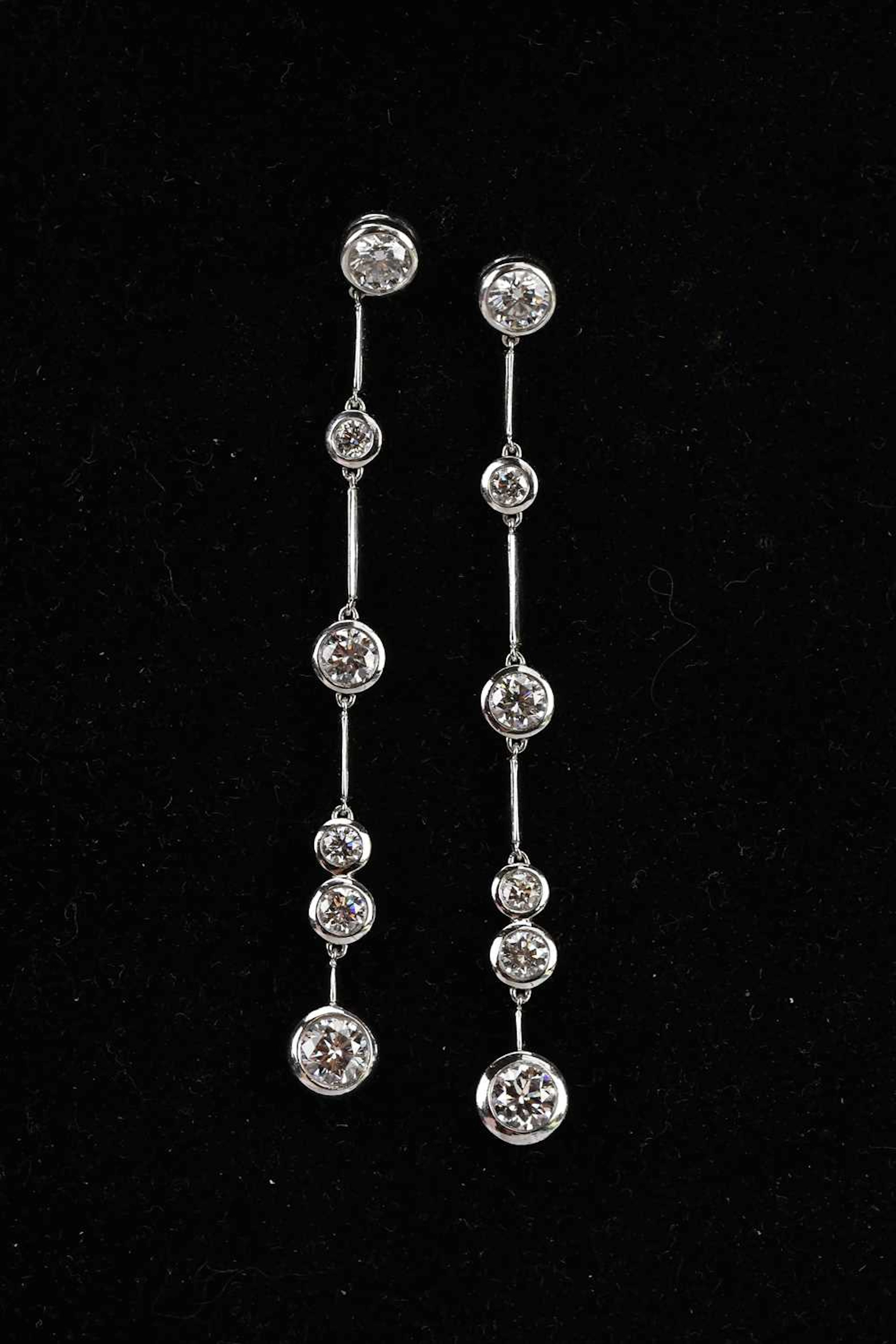 BOODLE & DUNTHORNE; a pair of platinum diamond set 'rainwater' drop earrings