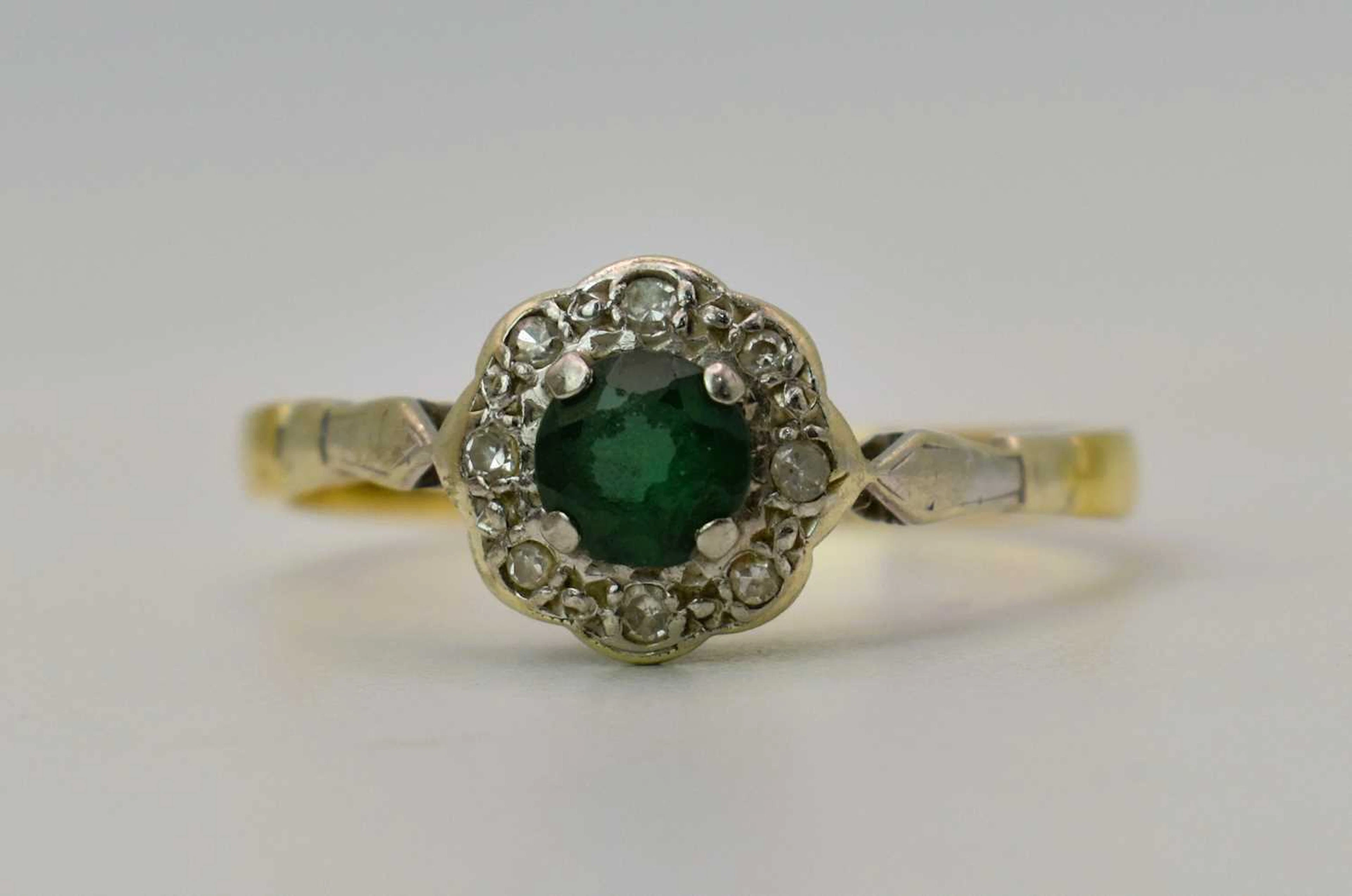 An 18ct gold and green stone cluster ring