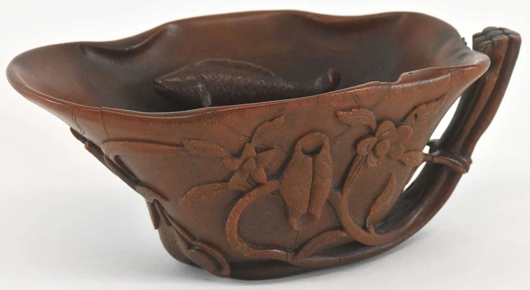 A rare and large 18th/19th century Chinese carved rhinoceros horn libation cup