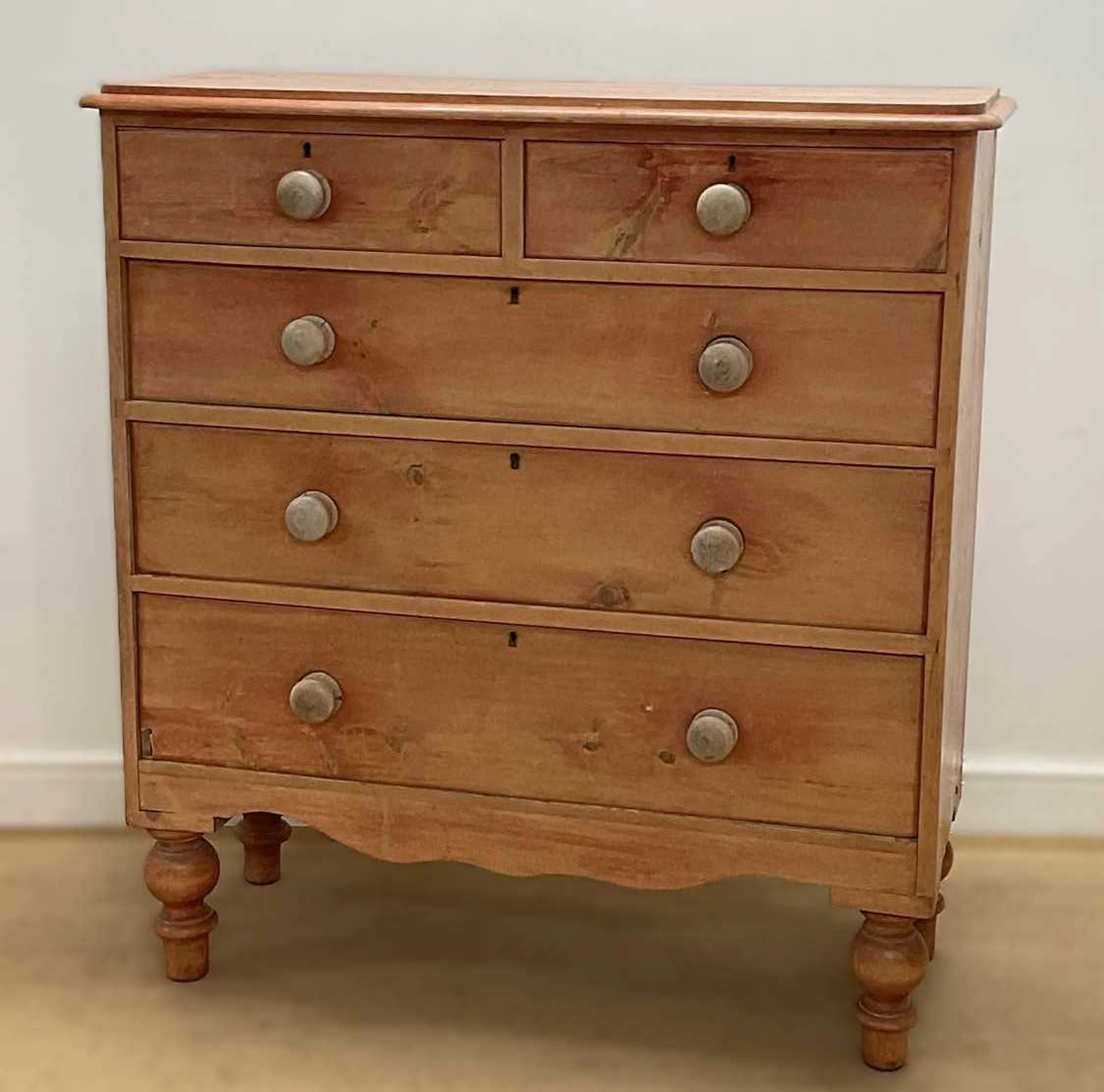 A pine chest of two short over three long drawers on turned legs
