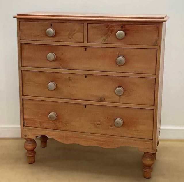 A pine chest of two short over three long drawers on turned legs
